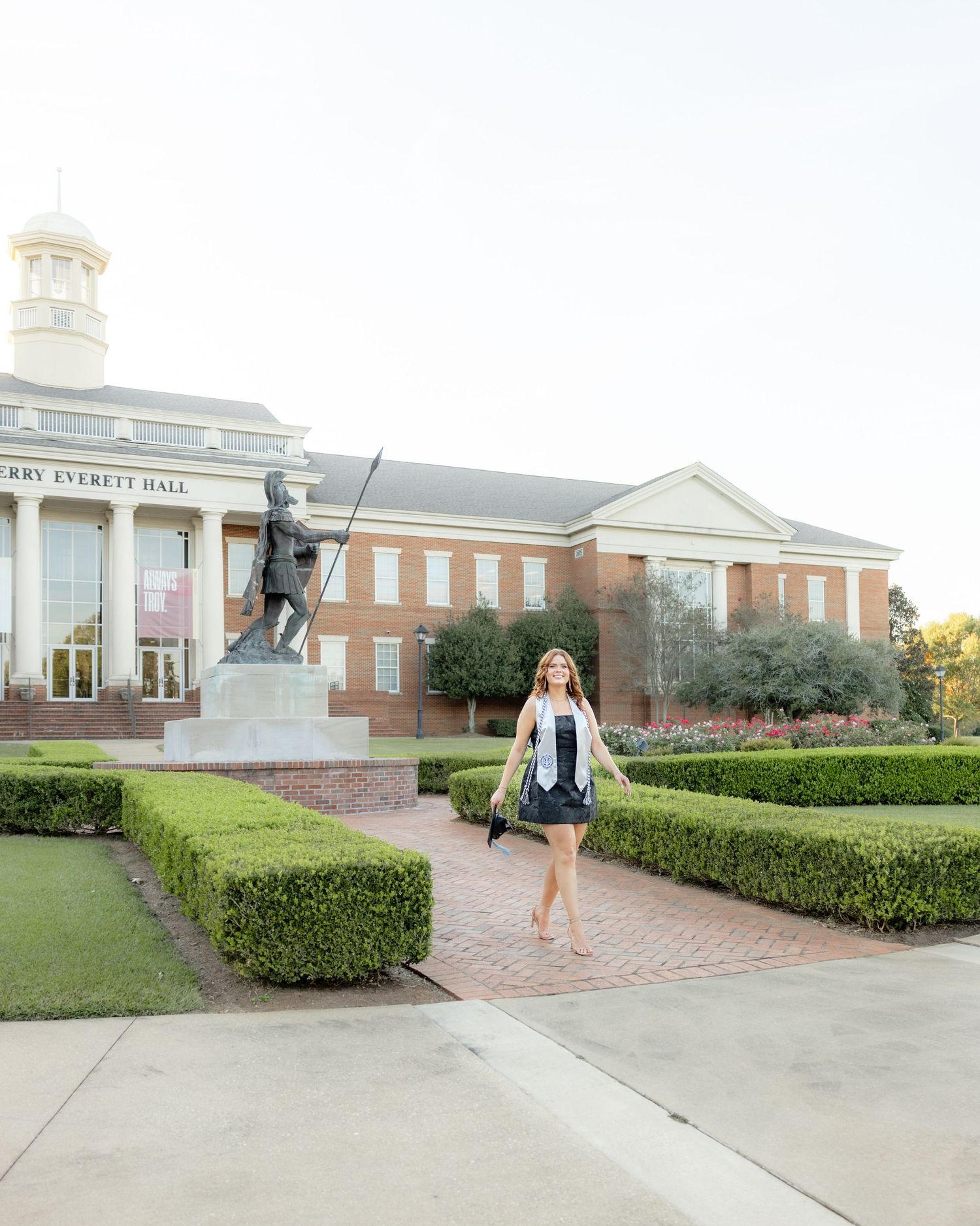 Senior walking across Troy University Dothan Campus