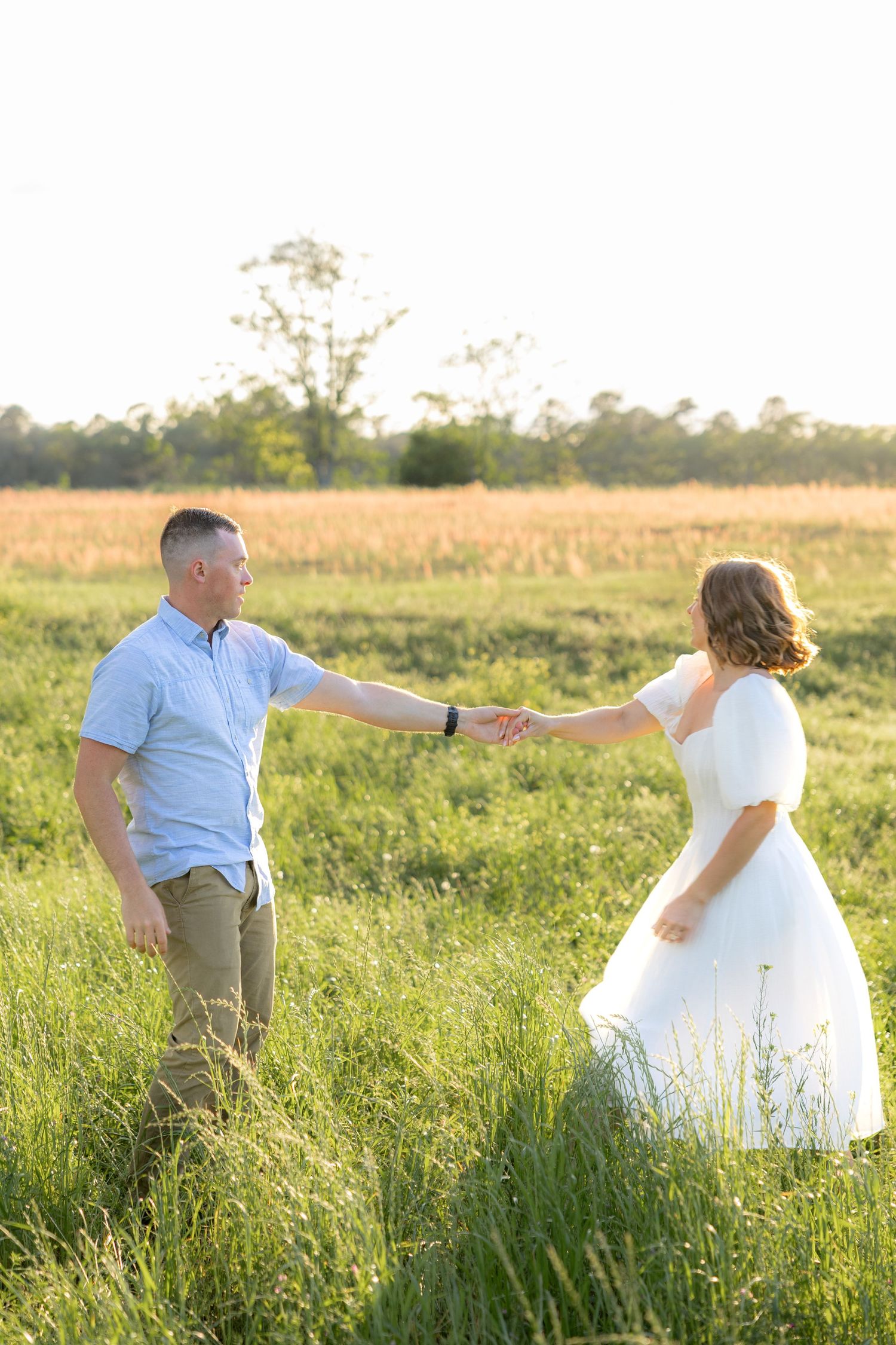 Storytelling couple photos in a tall grass field at sunset in Dothan, Alabama