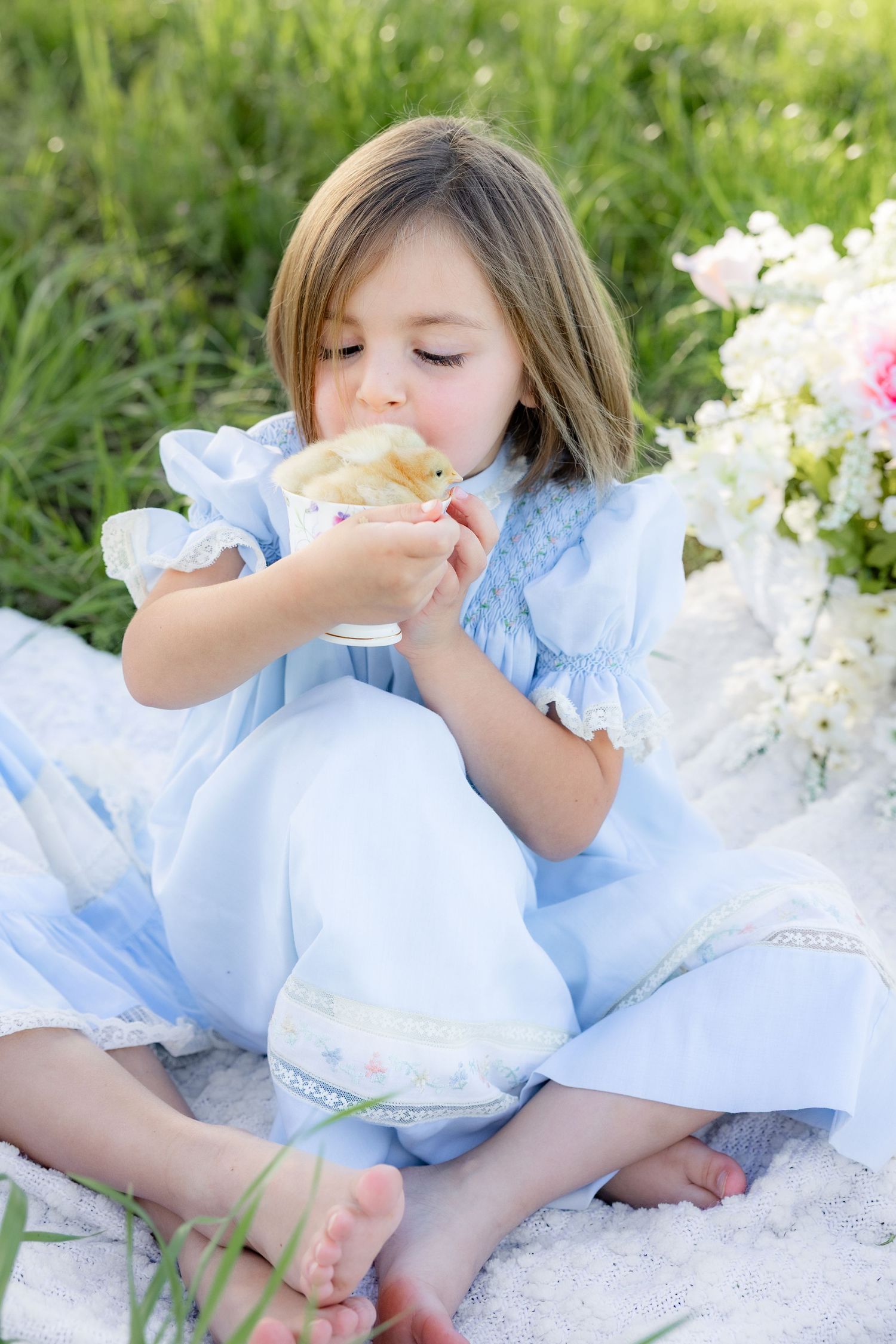 Spring Mini Session with baby chicks in a grass field at sunset near Dothan, Alabama