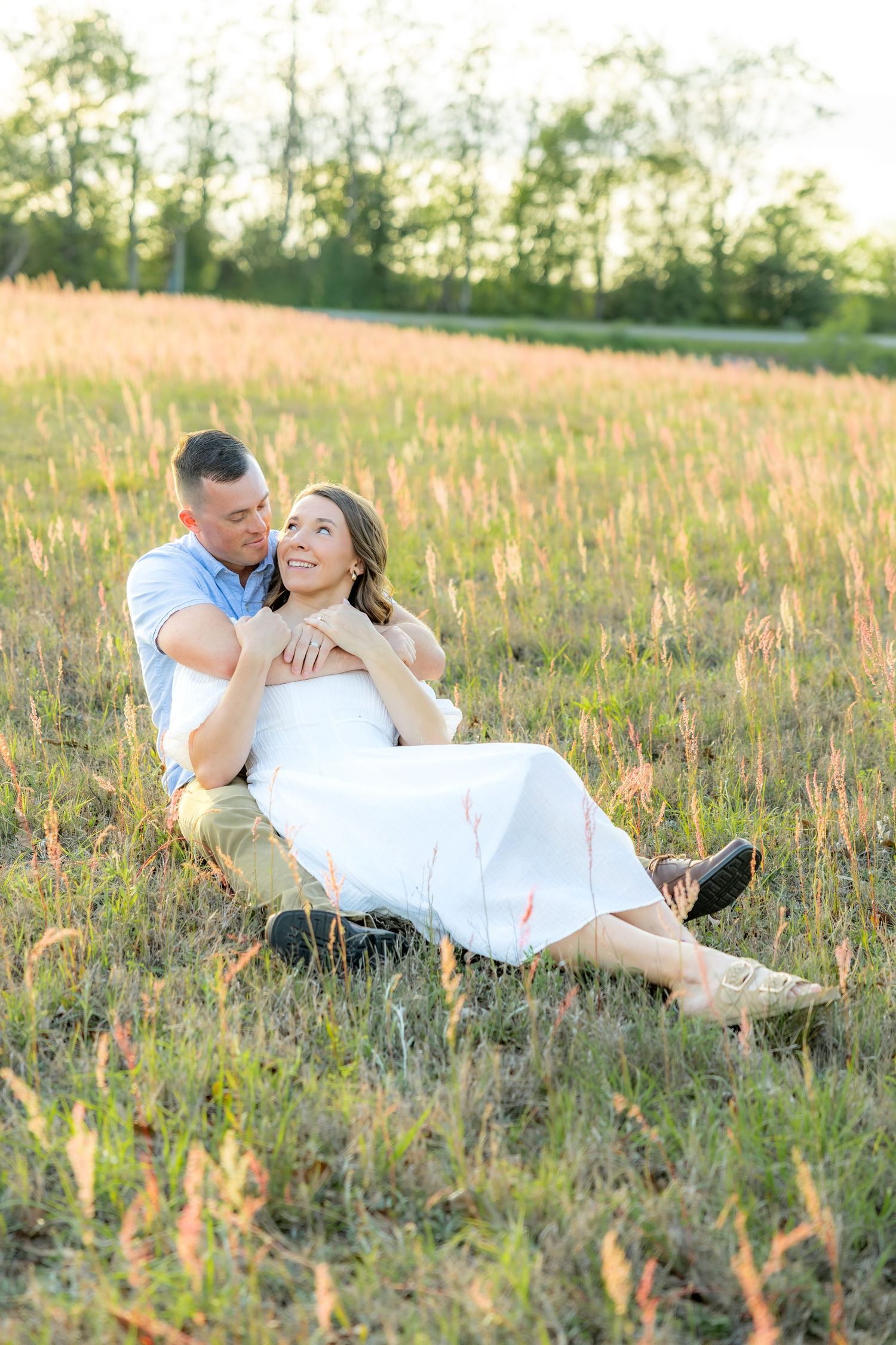 Storytelling couple photos in a tall grass field at sunset in Dothan, Alabama