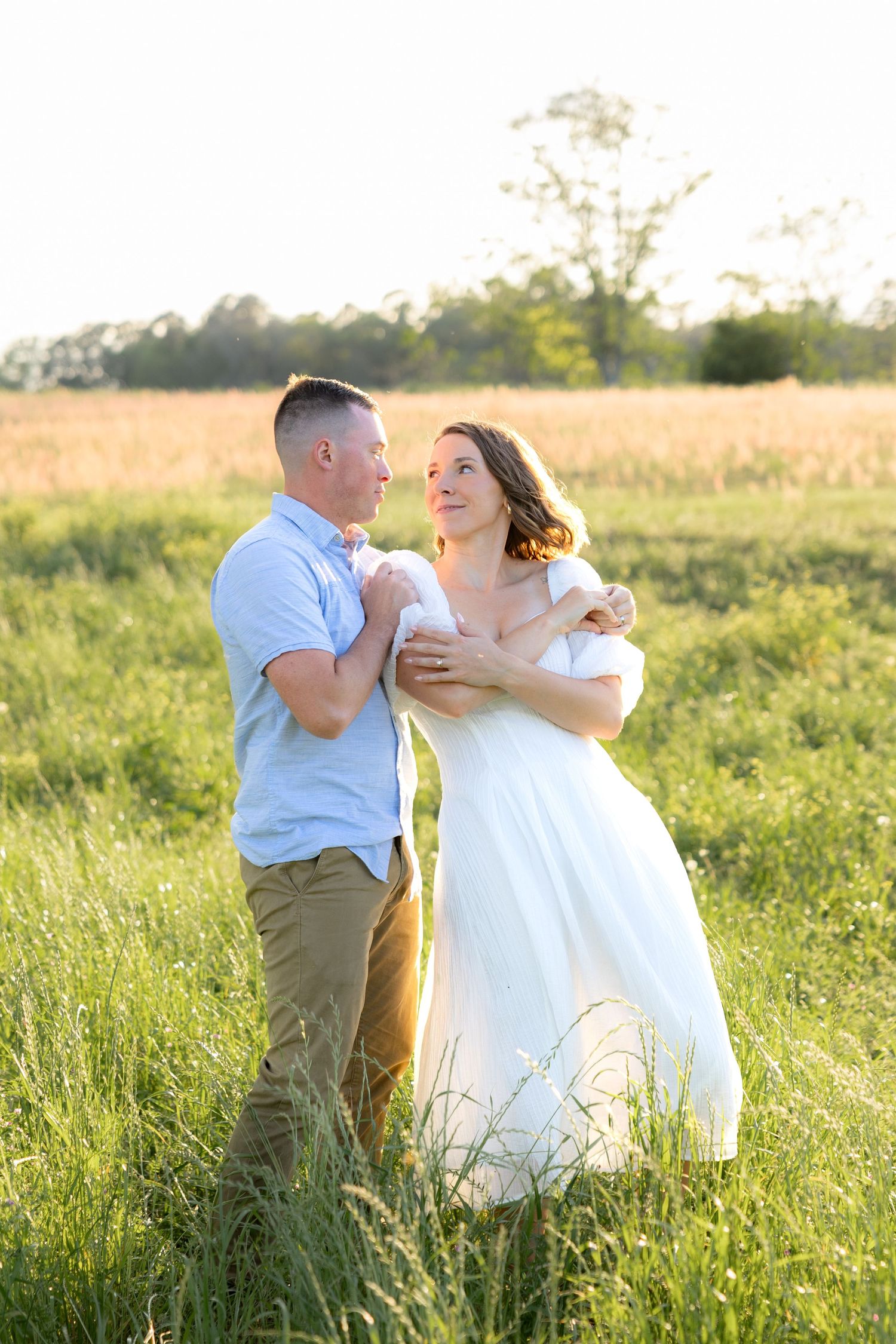 Storytelling couple photos in a tall grass field at sunset in Dothan, Alabama