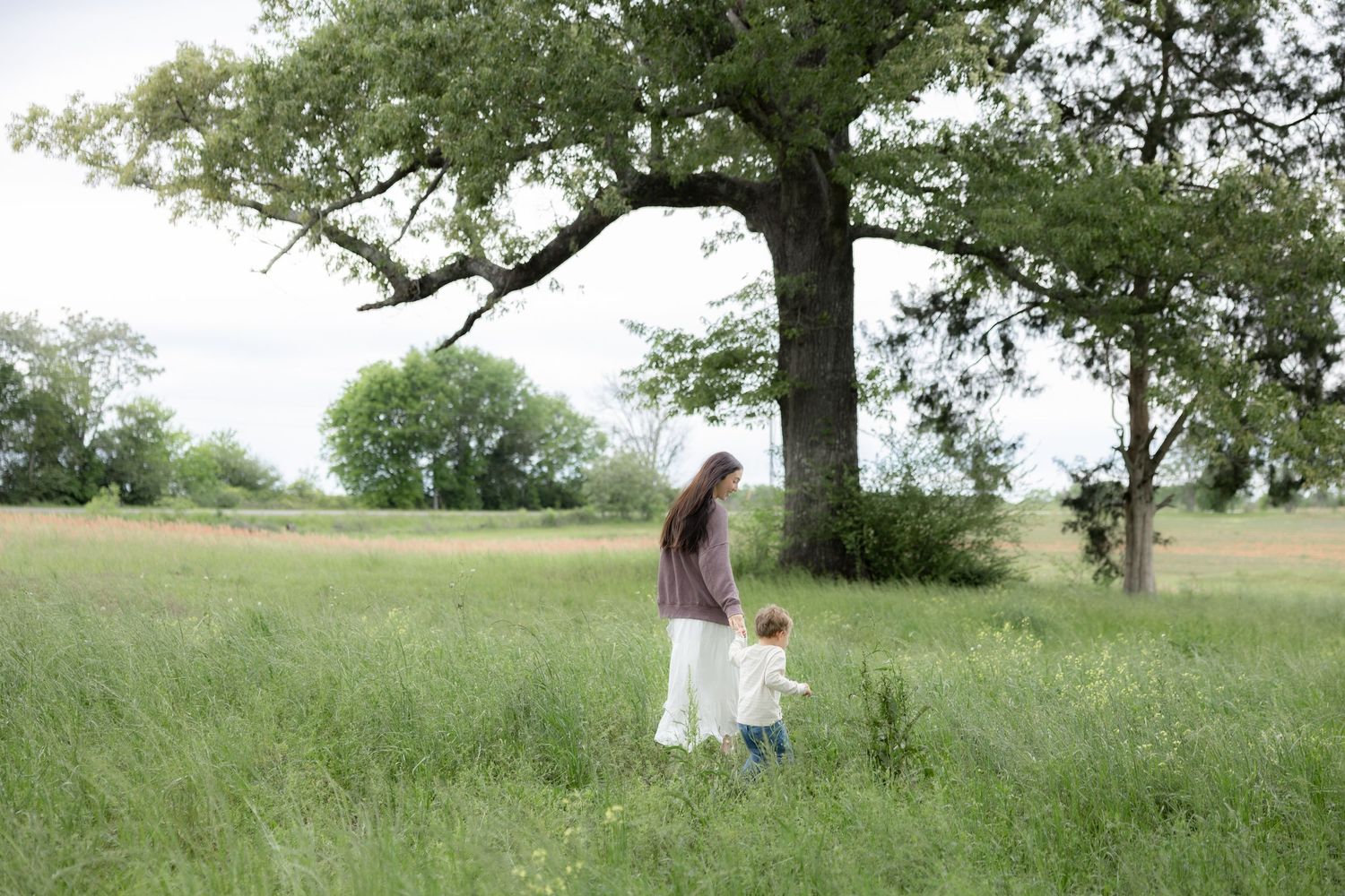 Candid family photos in a grass field | Dothan, Alabama Lifestyle Portrait Photographer