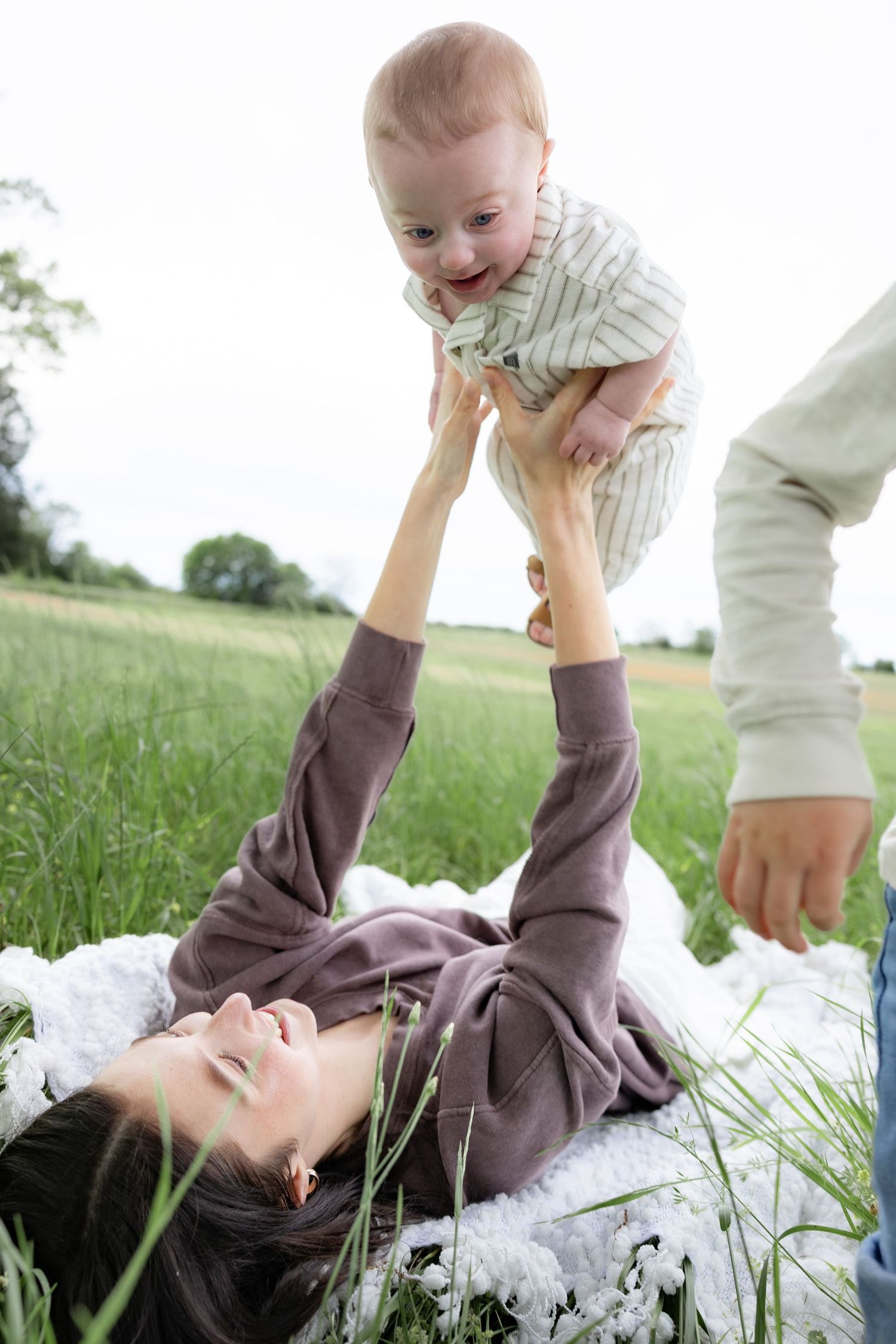 Candid family photos in a grass field | Dothan, Alabama Lifestyle Portrait Photographer