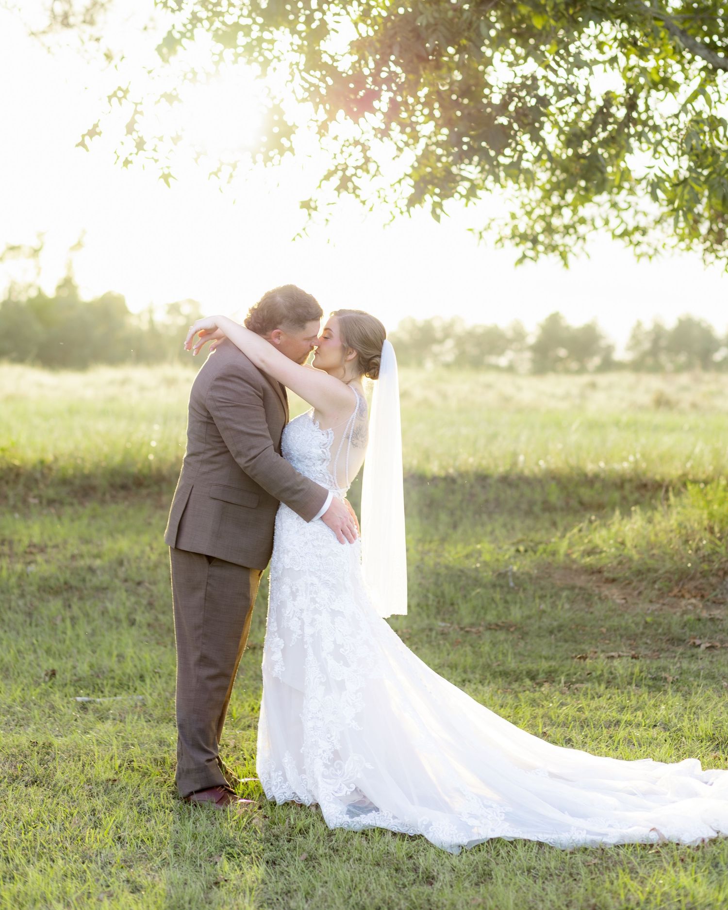 Bride and groom kiss at sunset at Hilltop Acres Wicksburg, Alabama
