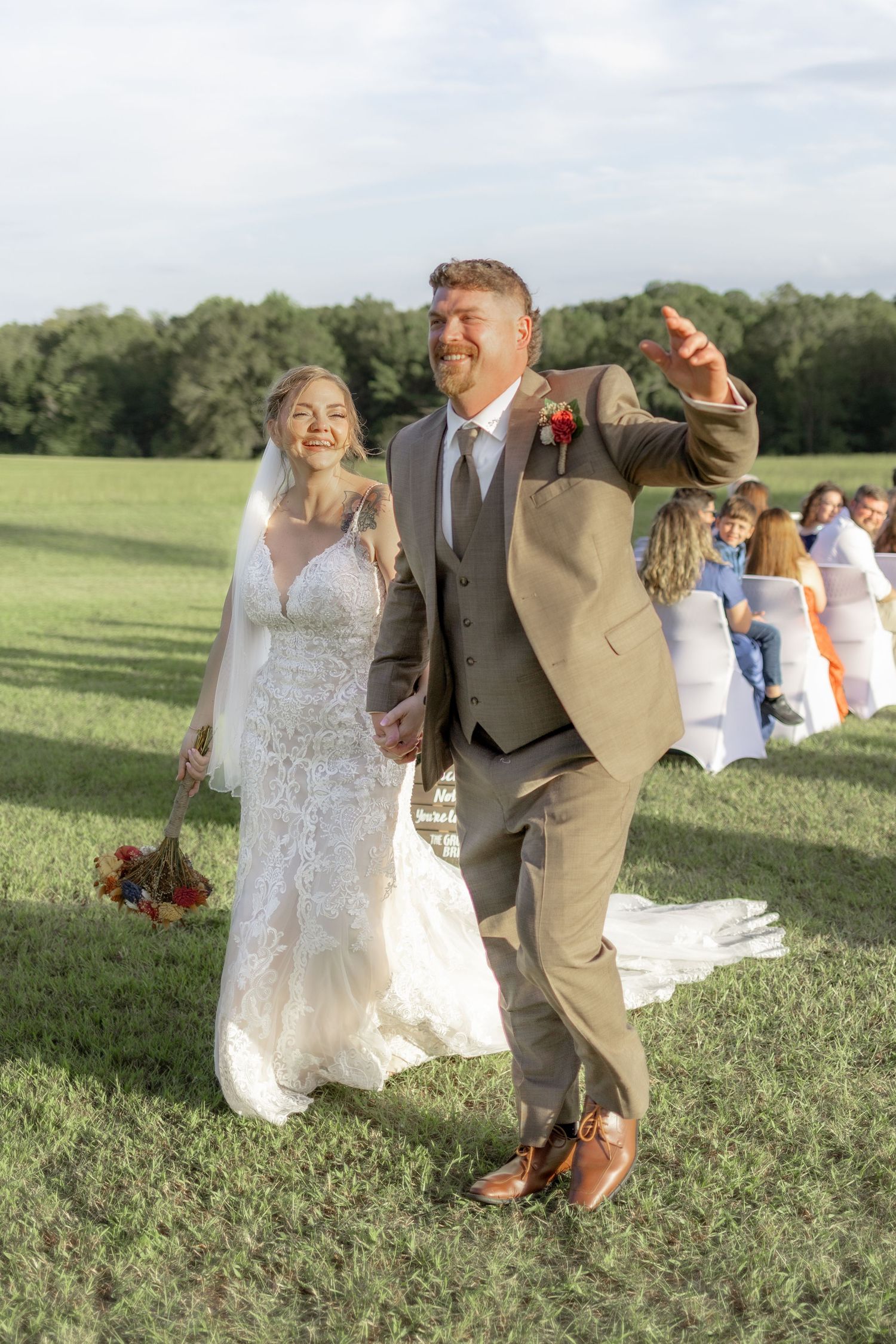 Bride and groom exiting their ceremony at Hilltop Acres Wicksburg, Alabama