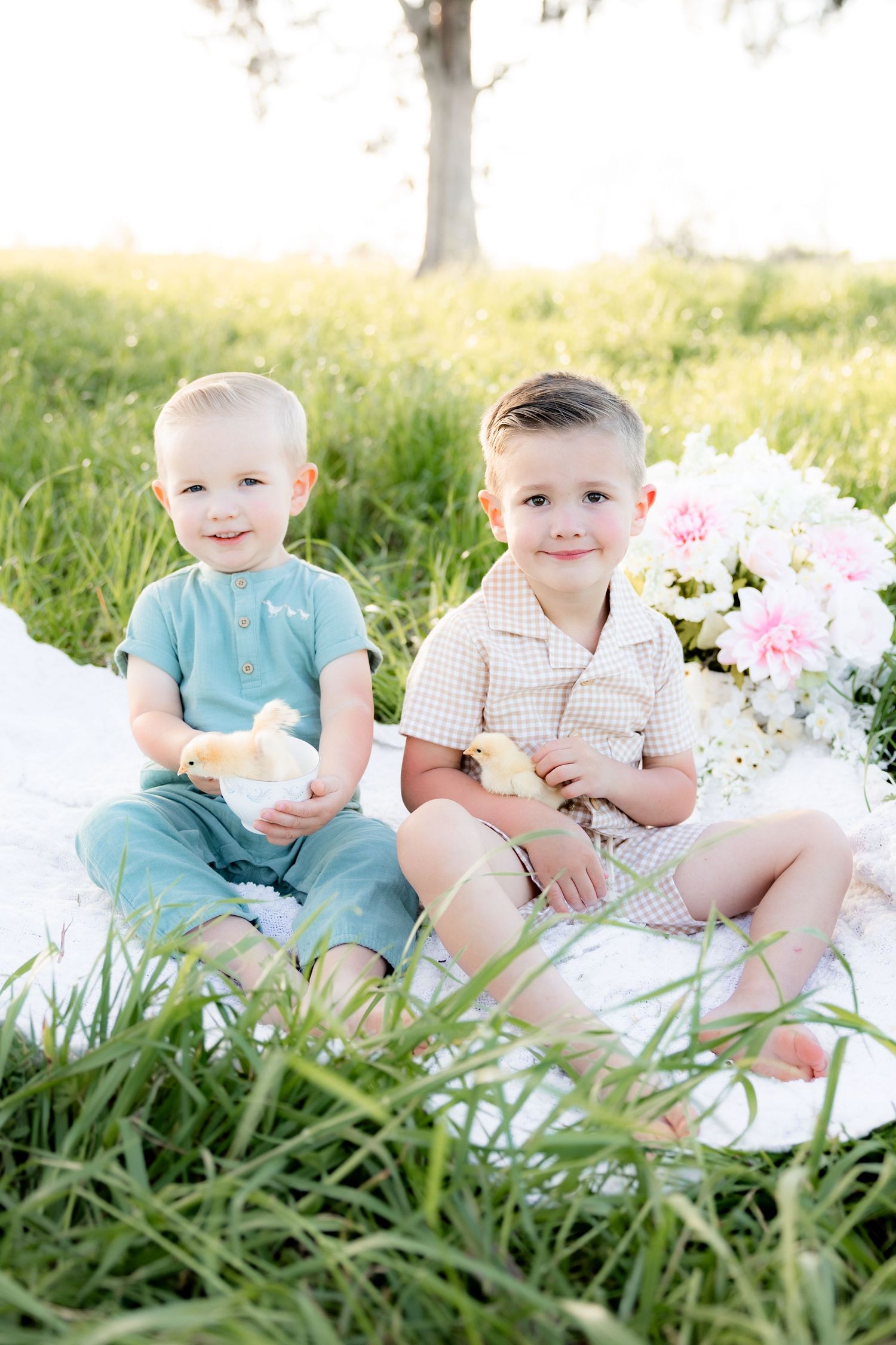 Spring Mini Session with baby chicks in a grass field at sunset near Dothan, Alabama