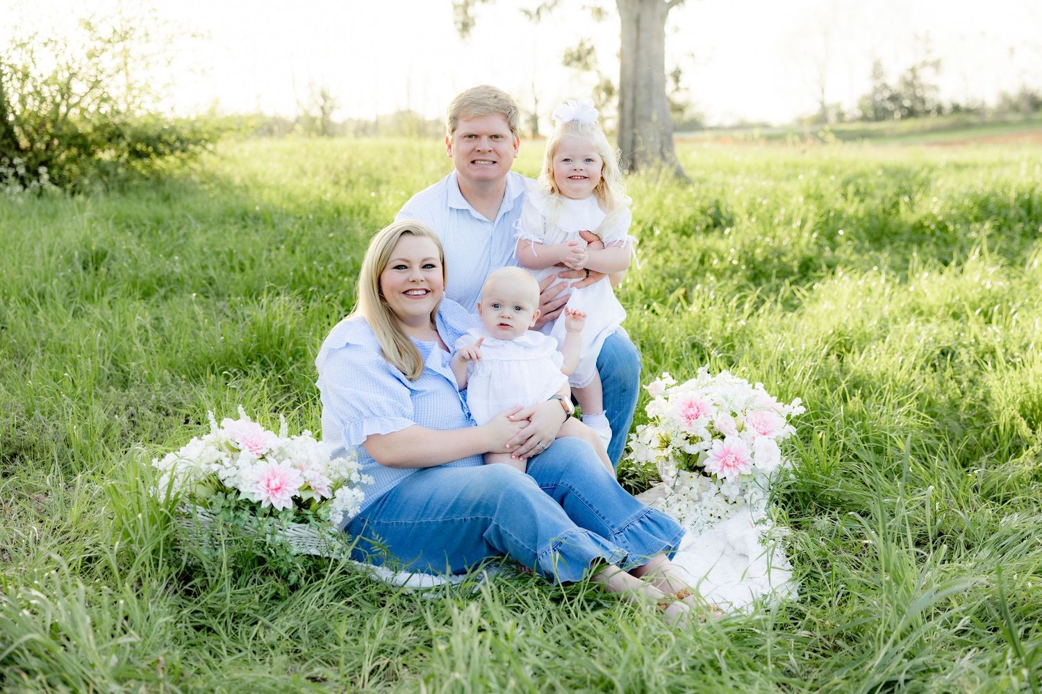 Spring Mini Session with baby chicks in a grass field at sunset near Dothan, Alabama