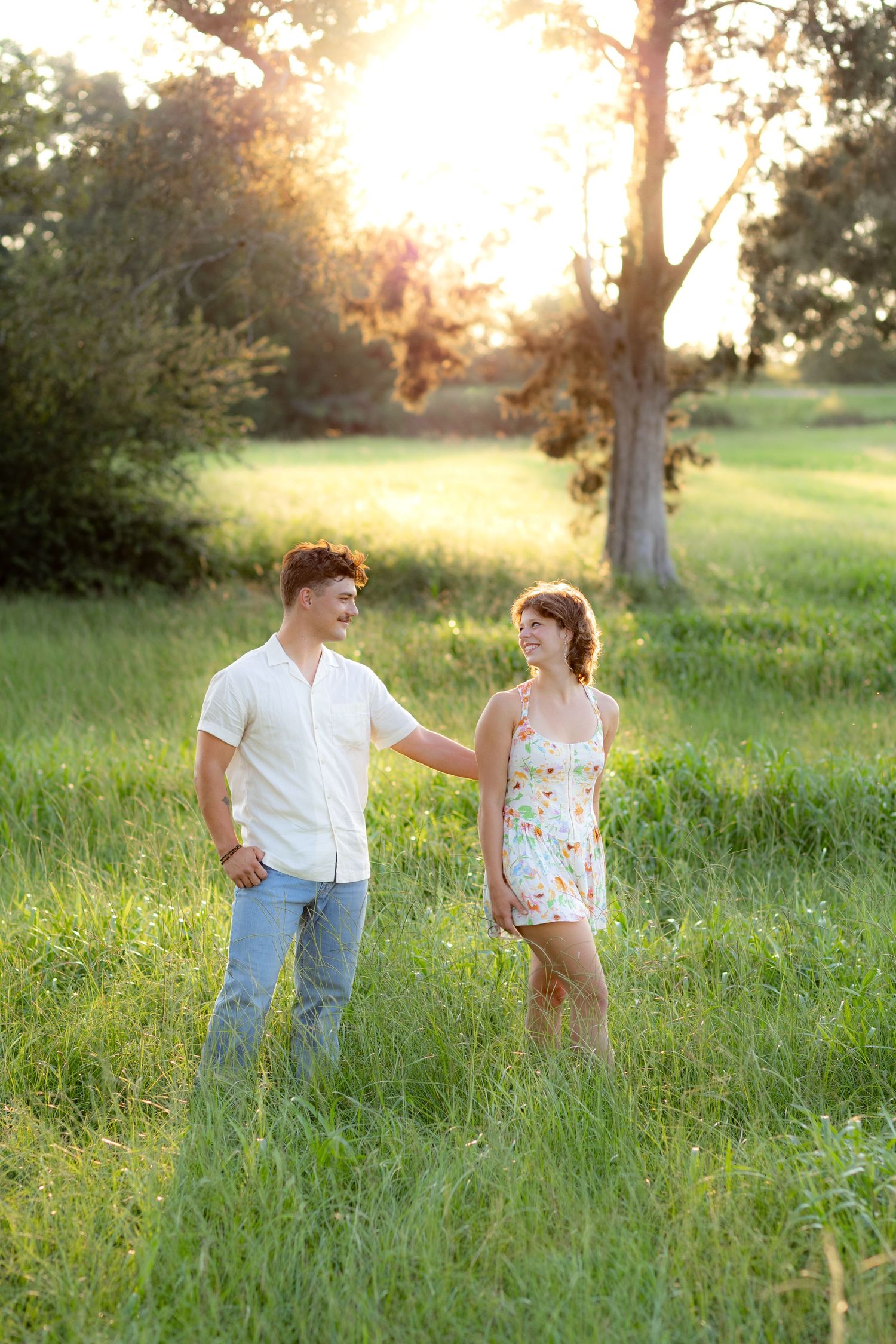 Romantic Couples photos in a tall grass field at sunset near Dothan, Alabama