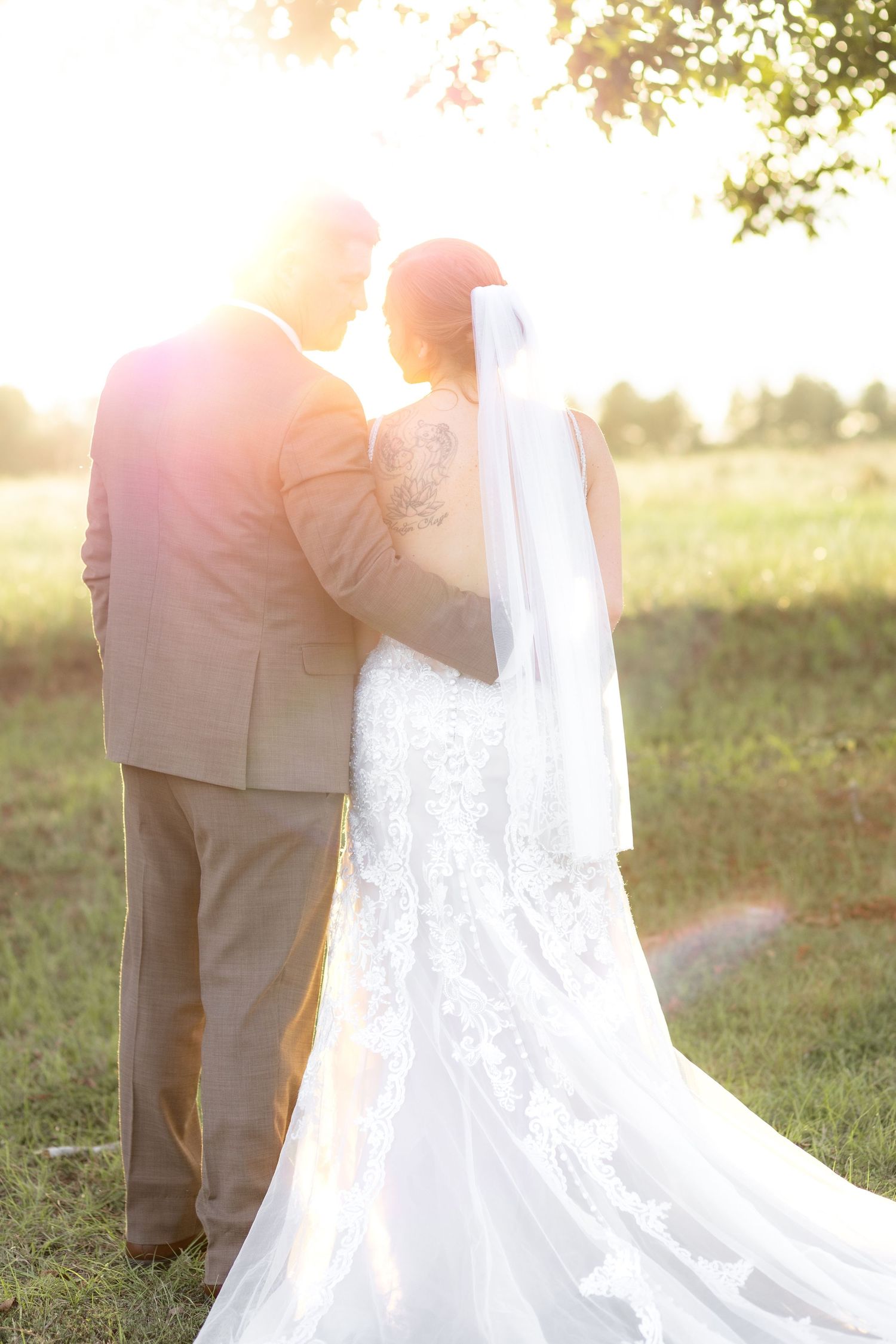 Bride and groom hold each other at sunset at Hilltop Acres Wicksburg, Alabama