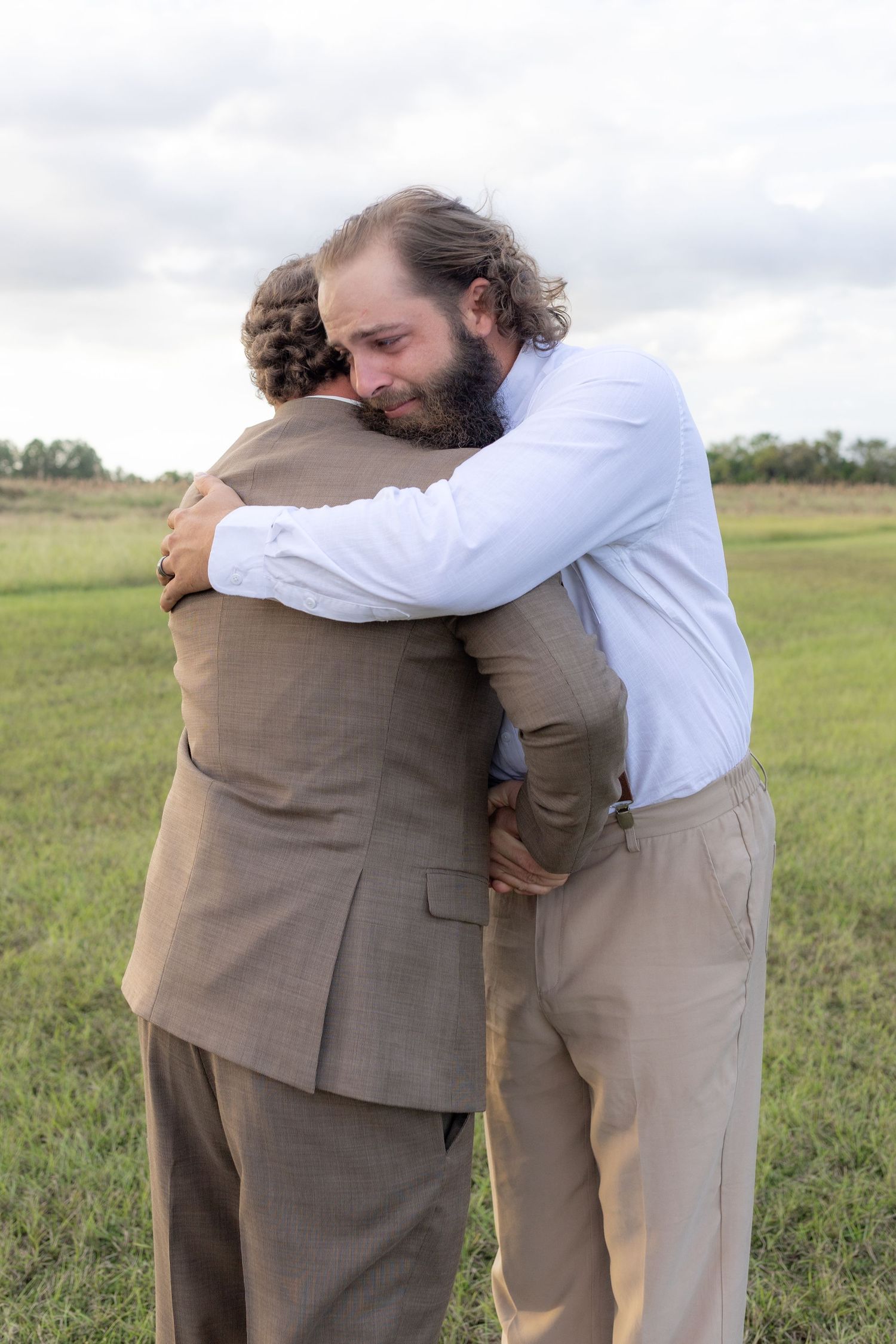 Bride's brother shaking the groom's hand before the wedding at Hilltop Acres Wicksburg, Alabama