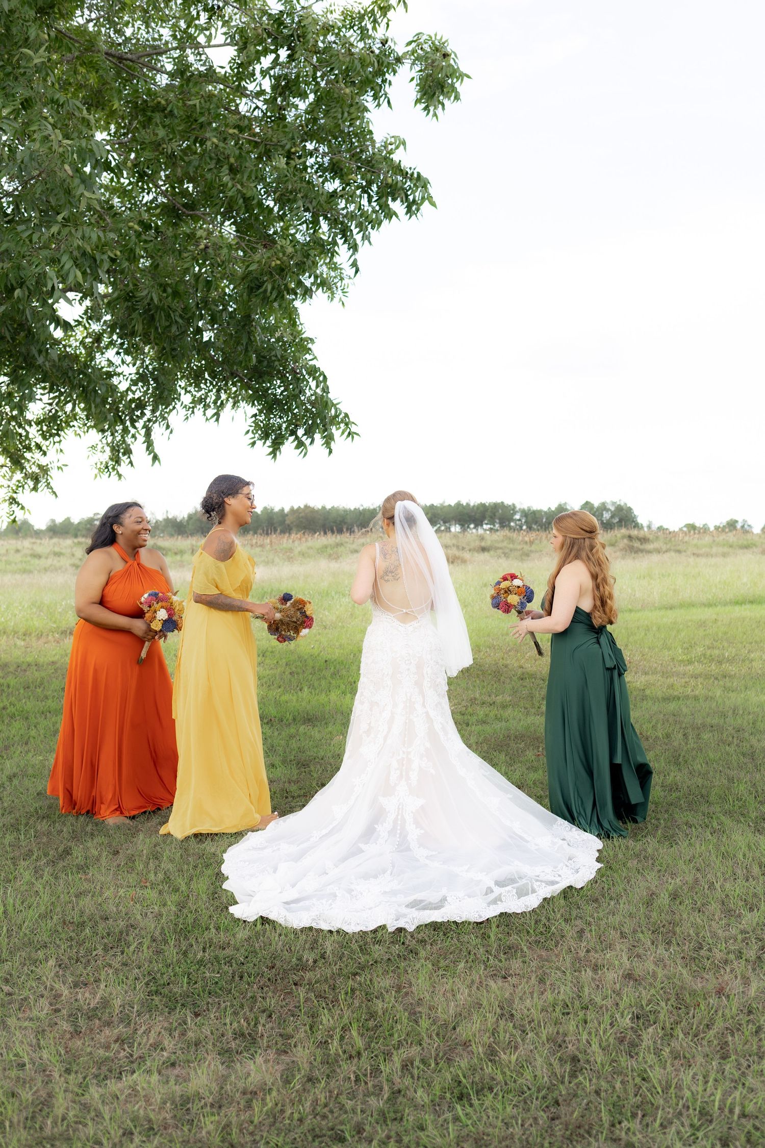 Bridal party posing in a field at sunset at Hilltop Acres Wicksburg, Alabama