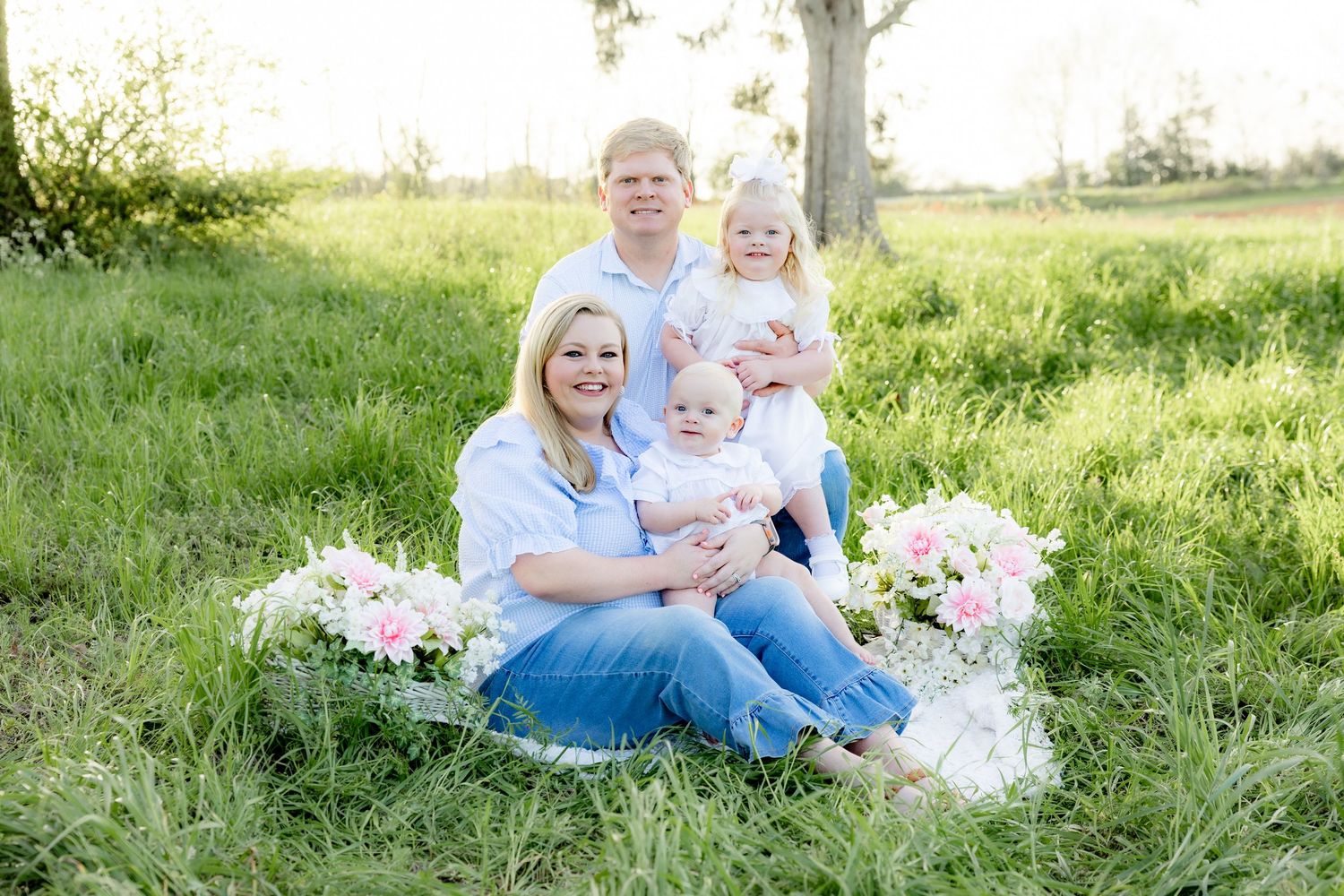 Spring Mini Session with baby chicks in a grass field at sunset near Dothan, Alabama