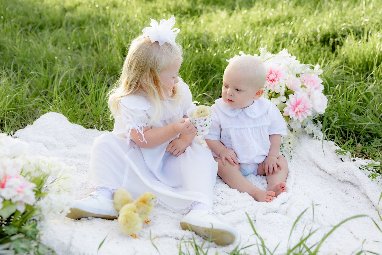Spring Mini Session with baby chicks in a grass field at sunset near Dothan, Alabama