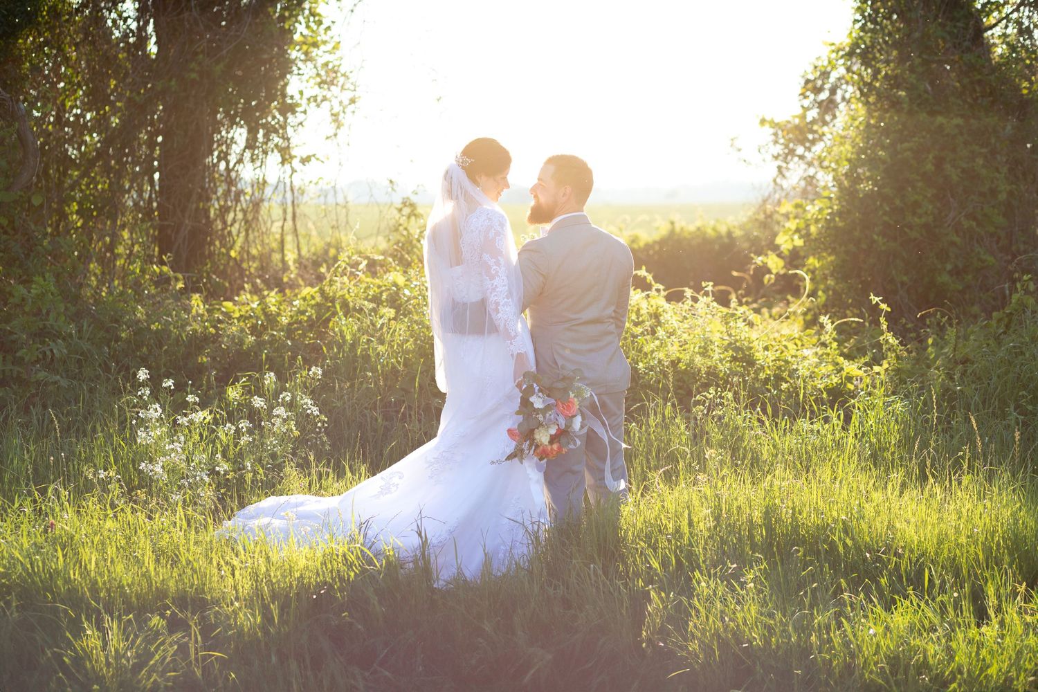 Romantic storybook couple photos in a grass field at sunset near Dothan, Alabama
