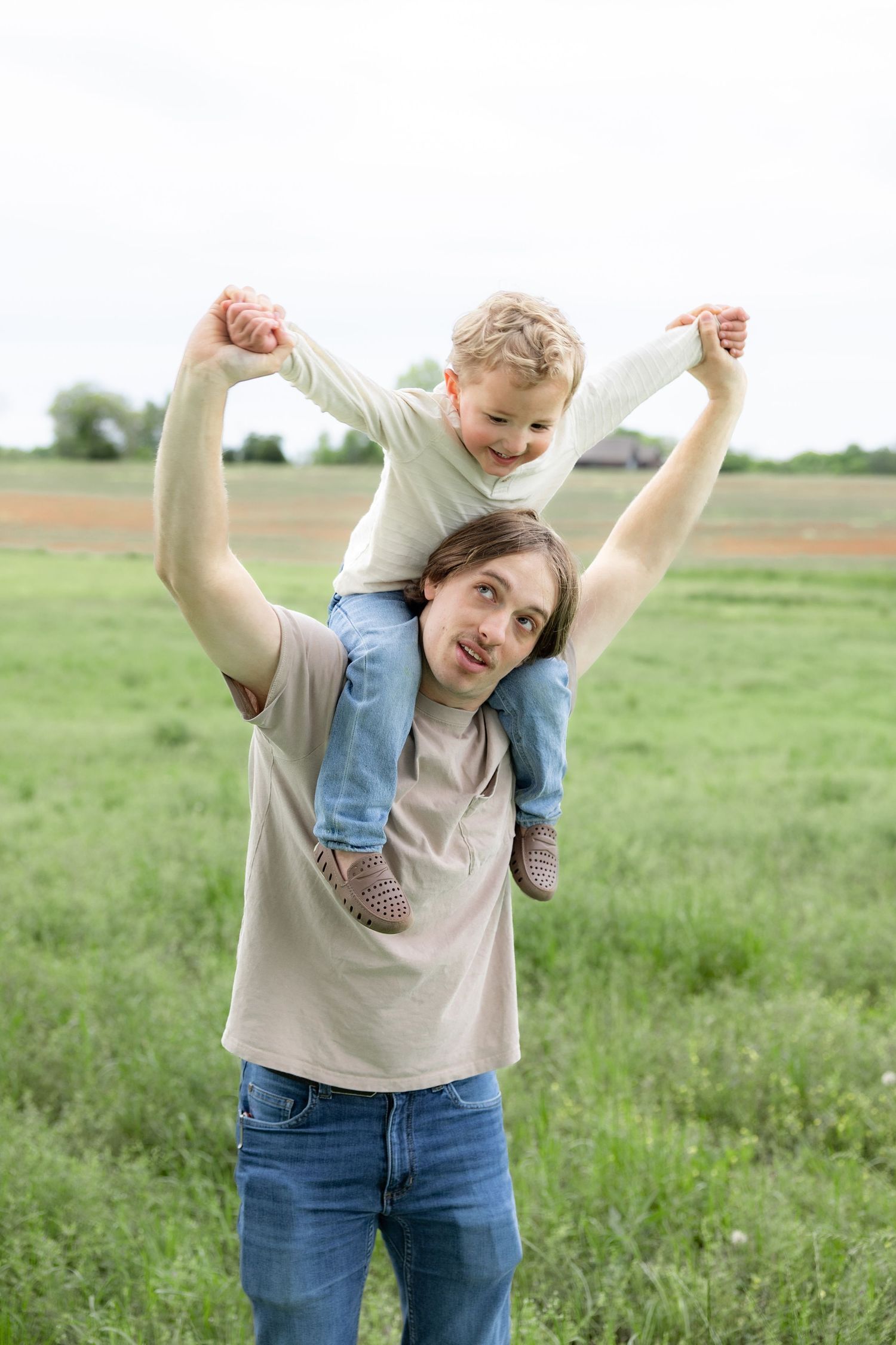 Candid family photos in a grass field | Dothan, Alabama Lifestyle Portrait Photographer