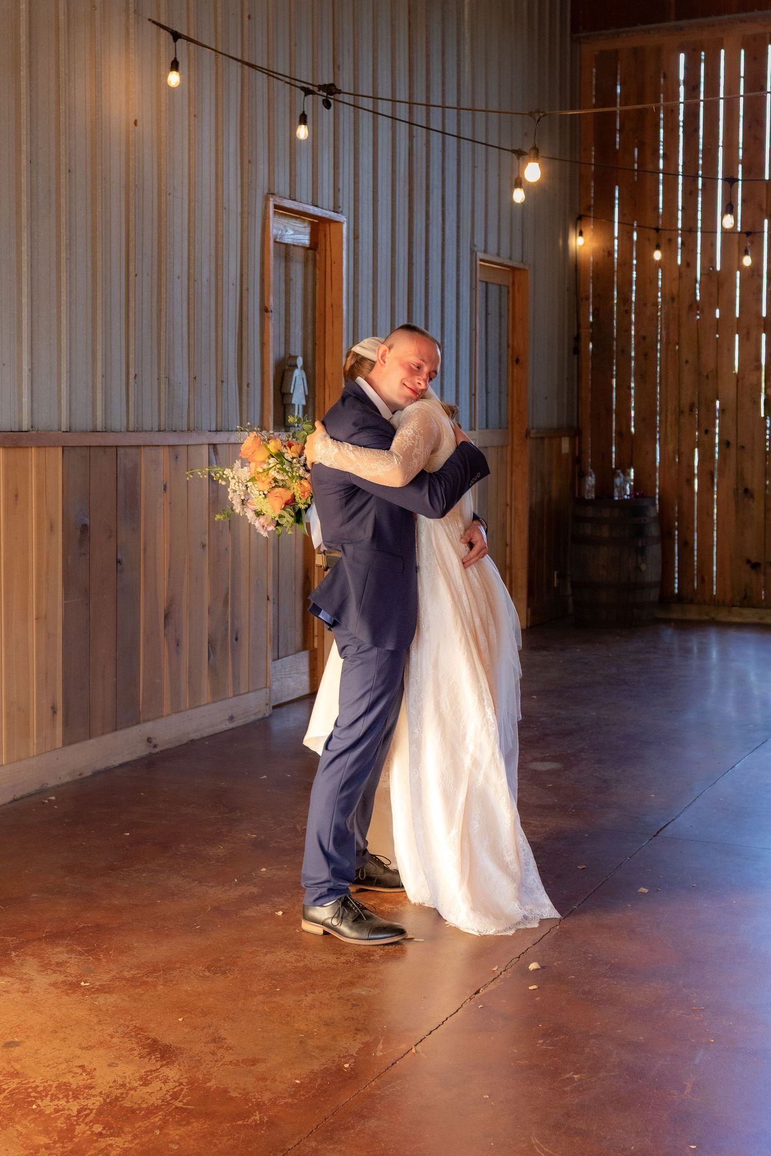 Bride and groom hug after getting married at Dalrymple Farms Enterprise, Alabama