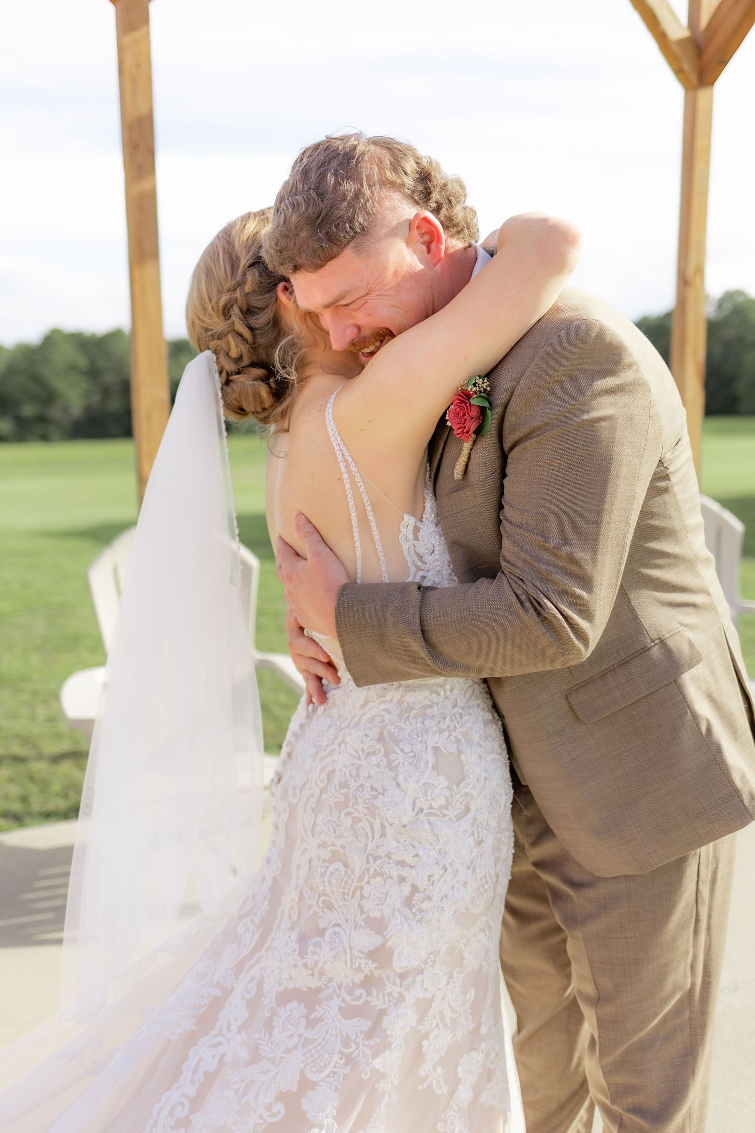 Groom first look with bride underneath the gazebo at Hilltop Acres Wicksburg, Alabama
