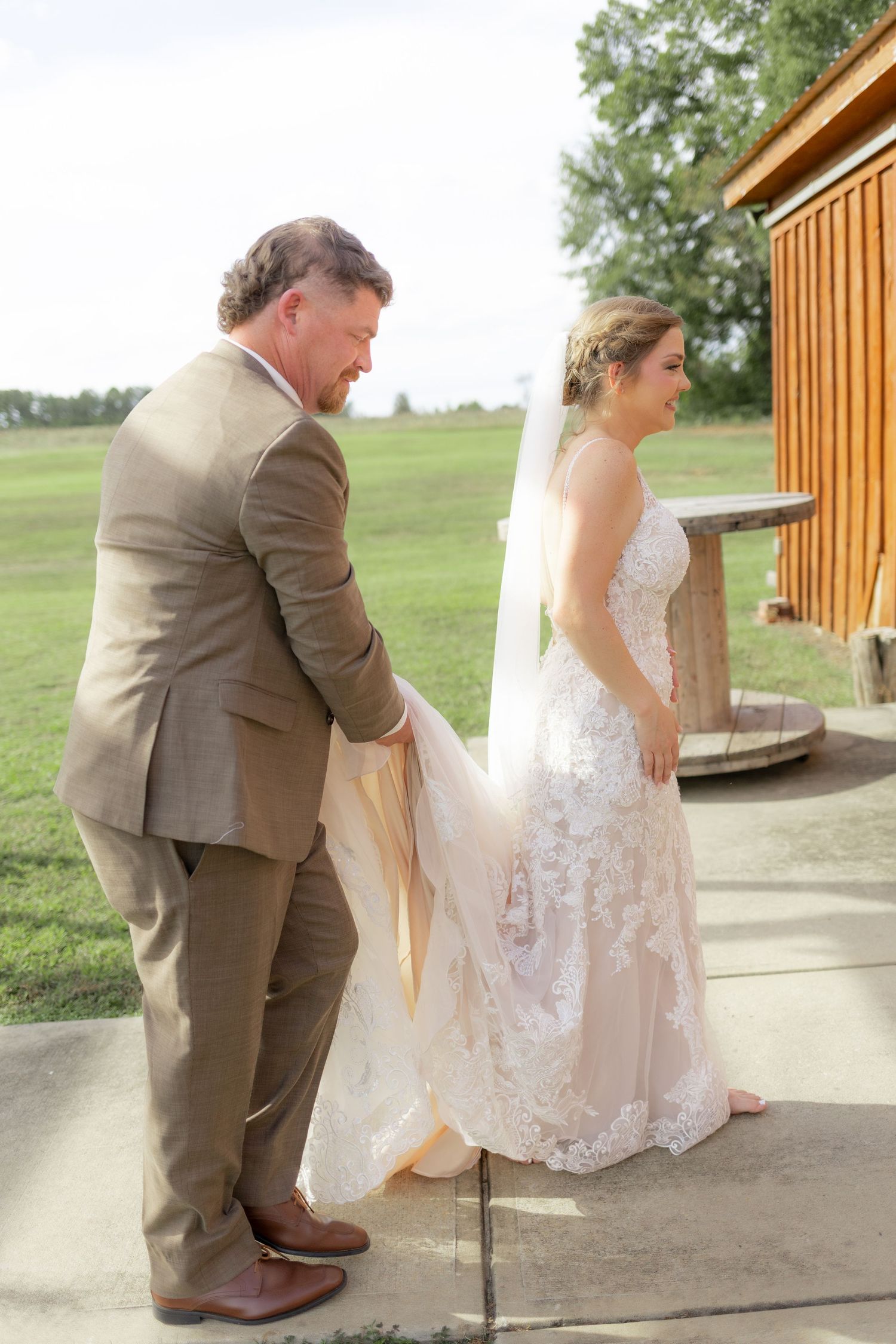 Groom first look with bride underneath the gazebo at Hilltop Acres Wicksburg, Alabama