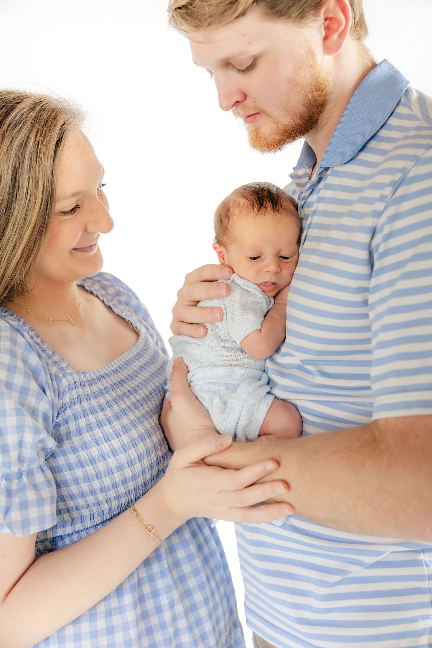Family holding their baby in a studio in Dothan, Alabama