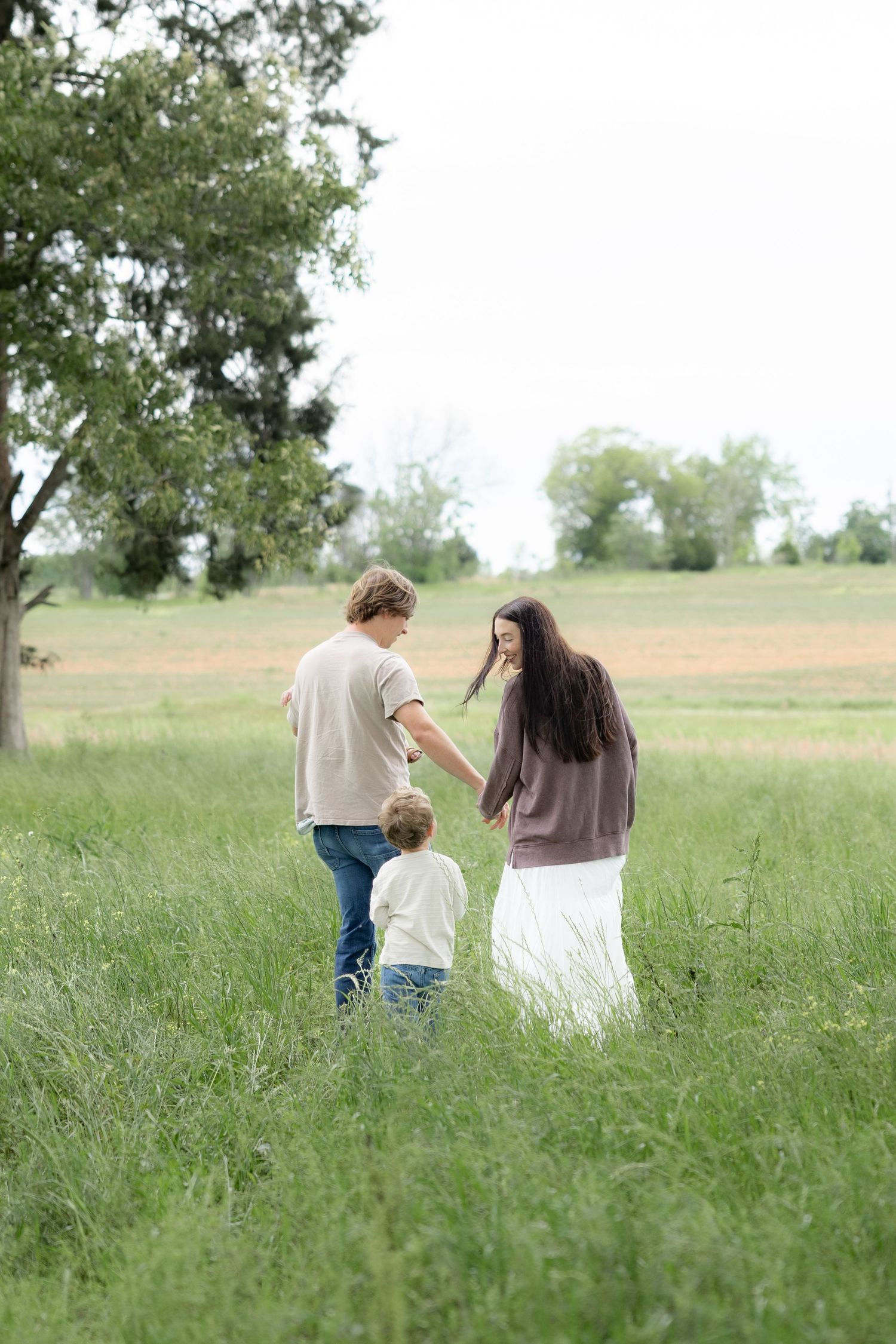 Candid family photos in a grass field | Dothan, Alabama Lifestyle Portrait Photographer
