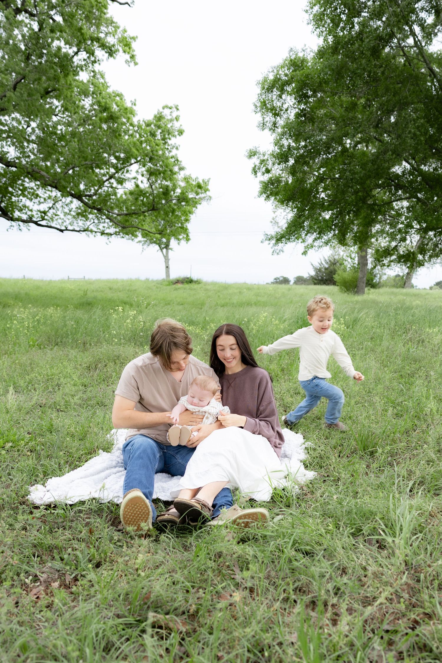 Candid family photos in a grass field | Dothan, Alabama Lifestyle Portrait Photographer