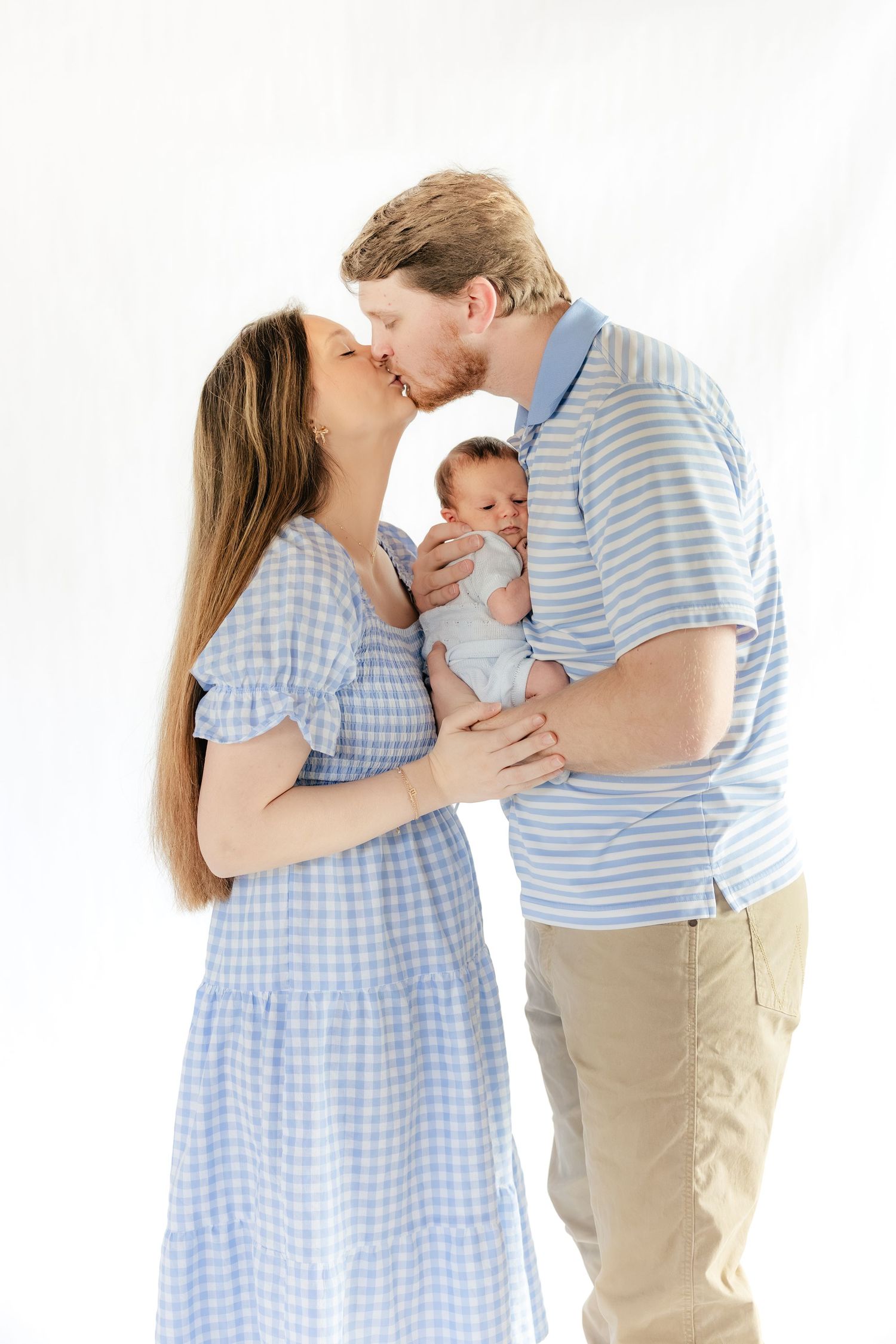 Family holding their baby in a studio in Dothan, Alabama