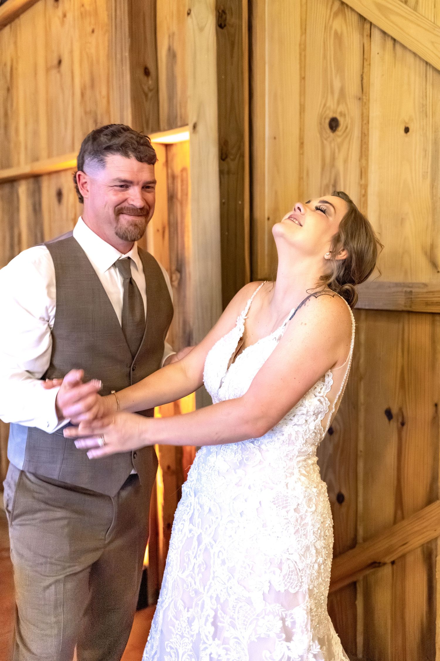 Bride and groom eat cake at their barn wedding at Hilltop Acres Wicksburg, Alabama