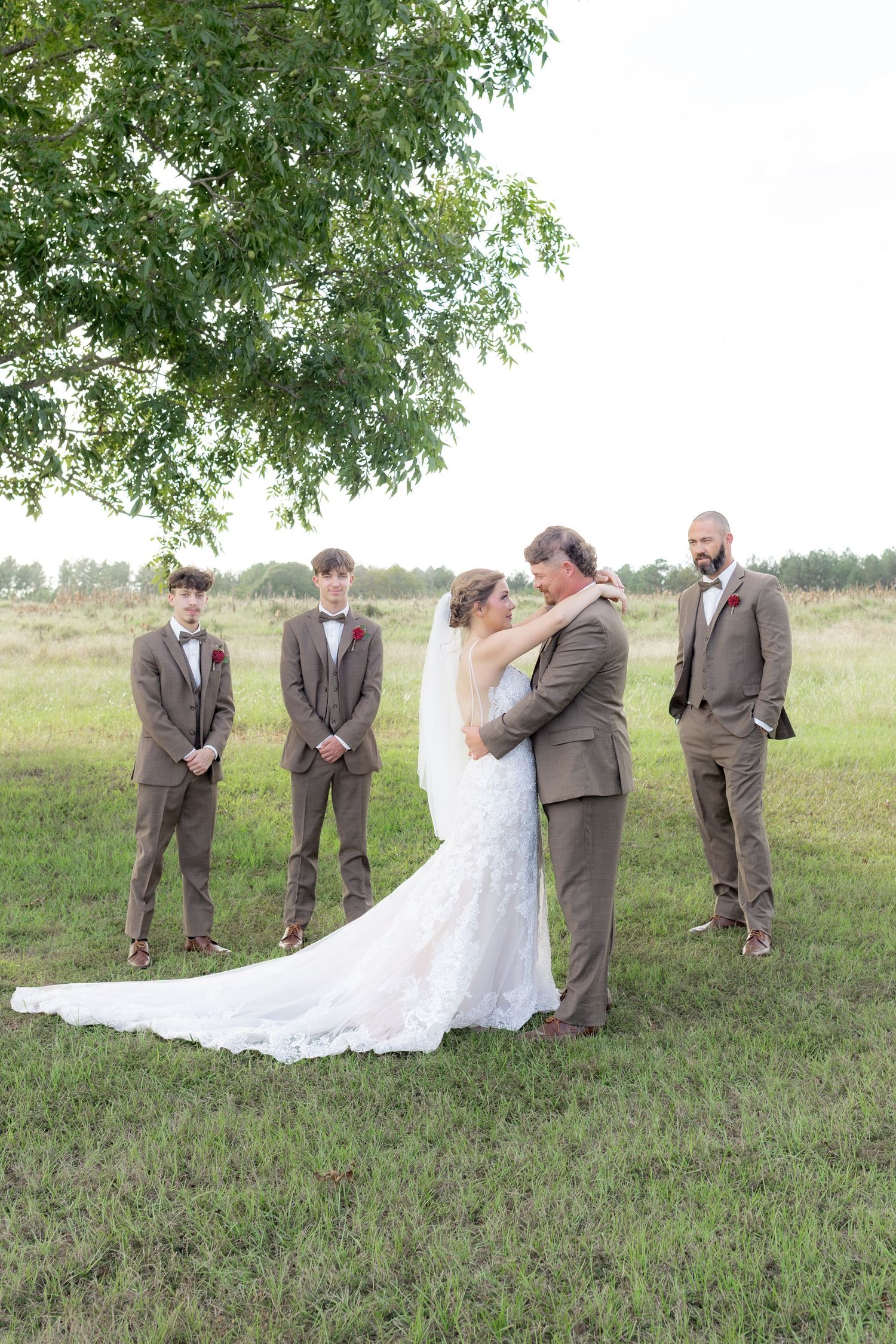 Bridal party posing in a field at sunset at Hilltop Acres Wicksburg, Alabama