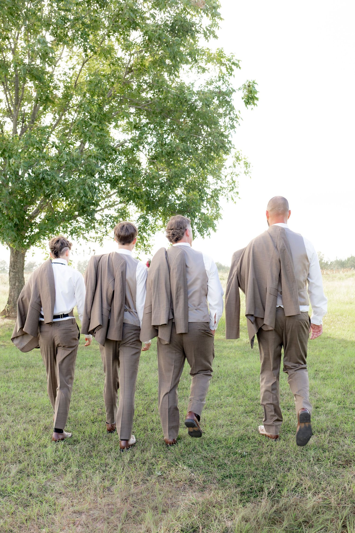 Bridal party posing in a field at sunset at Hilltop Acres Wicksburg, Alabama