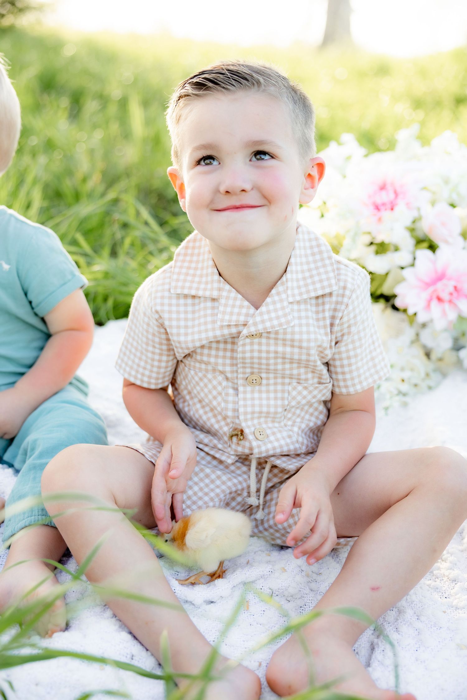 Spring Mini Session with baby chicks in a grass field at sunset near Dothan, Alabama