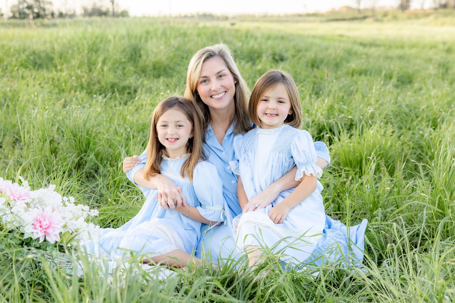 Spring Mini Session with baby chicks in a grass field at sunset near Dothan, Alabama