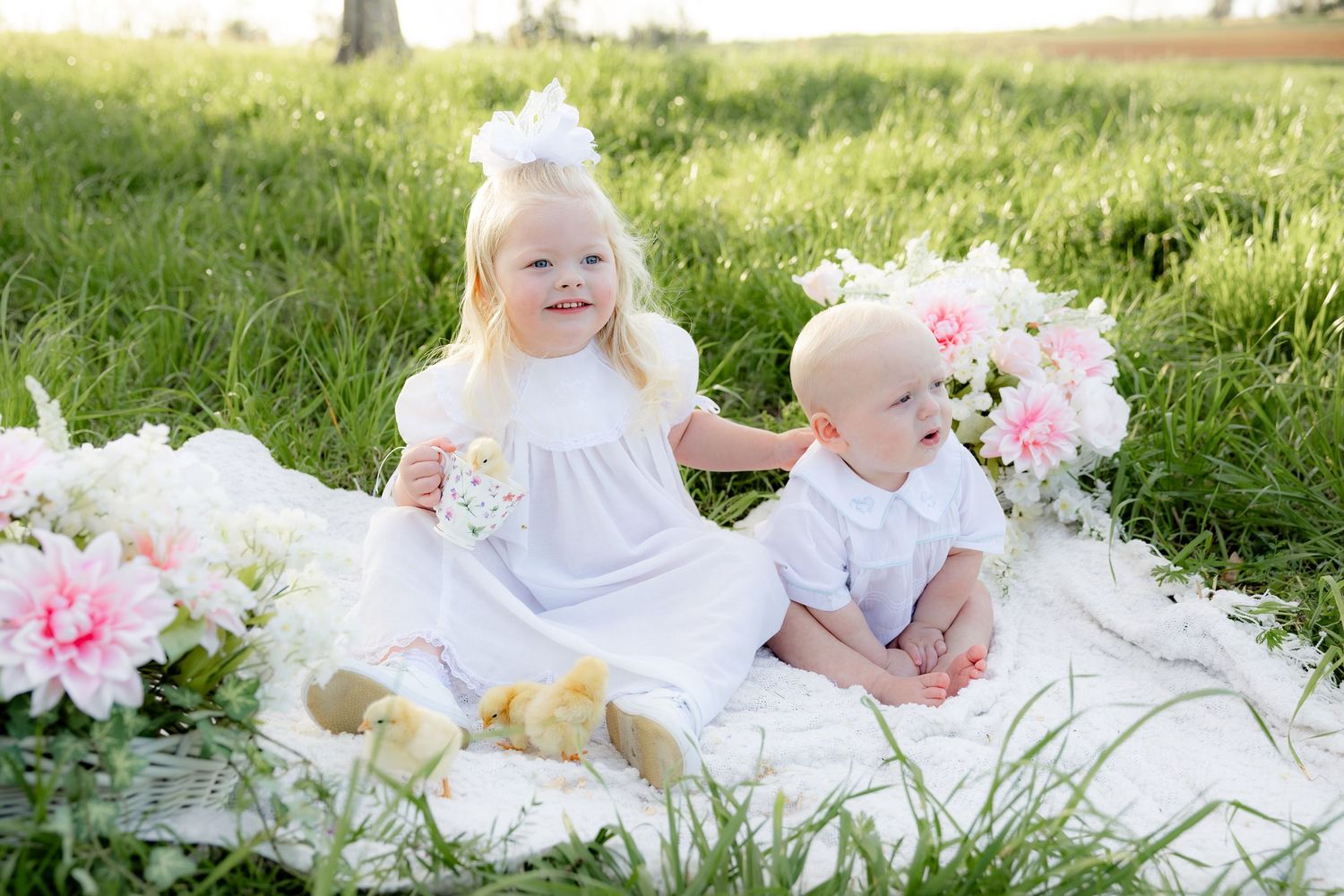 Spring Mini Session with baby chicks in a grass field at sunset near Dothan, Alabama