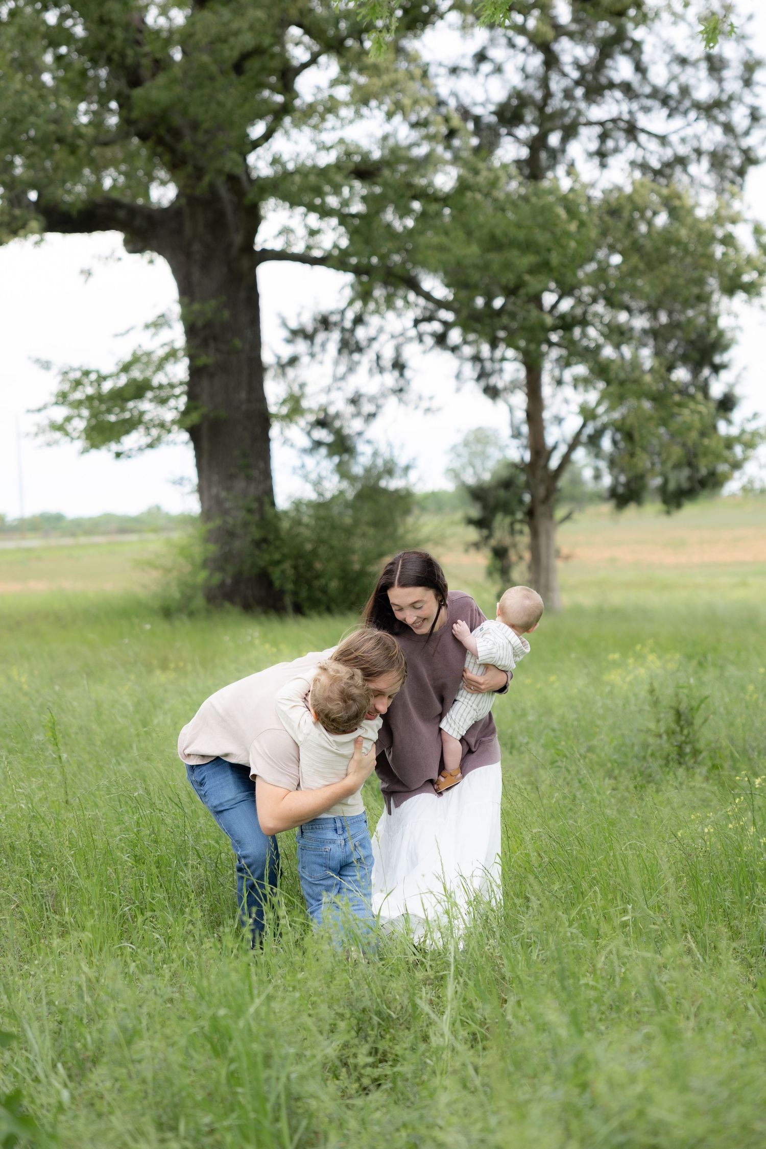 Candid family photos in a grass field | Dothan, Alabama Lifestyle Portrait Photographer