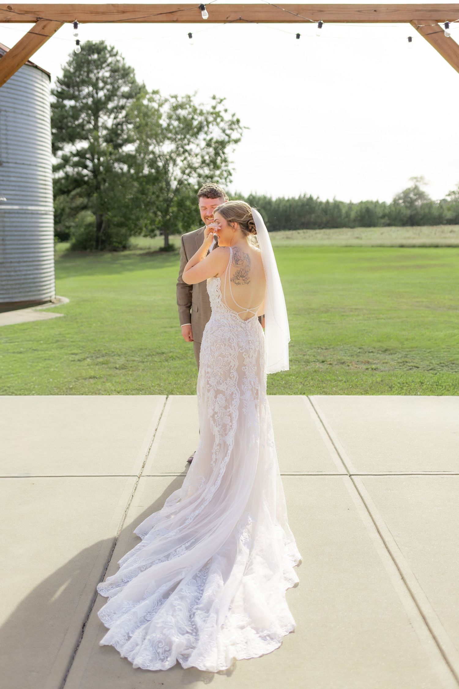 Groom first look with bride underneath the gazebo at Hilltop Acres Wicksburg, Alabama