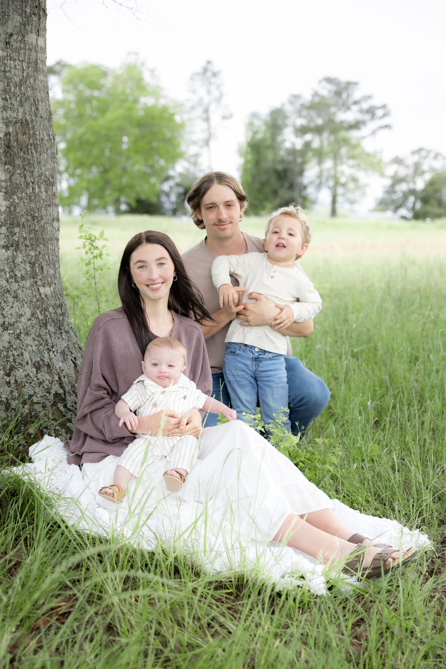Candid family photos in a grass field | Dothan, Alabama Lifestyle Portrait Photographer