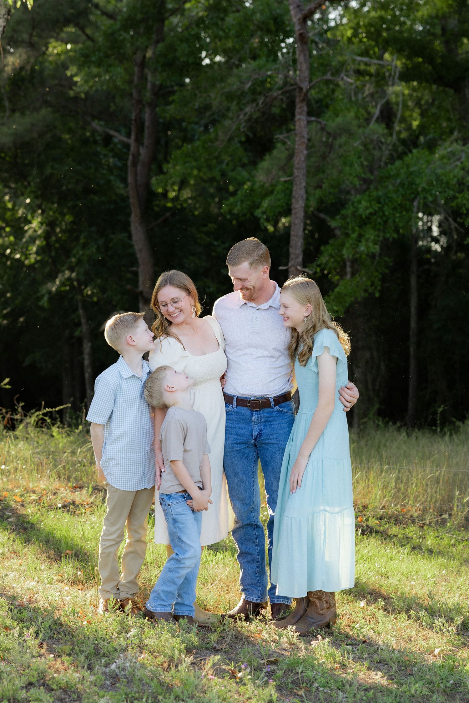 Family photos at golden hour in a grass field