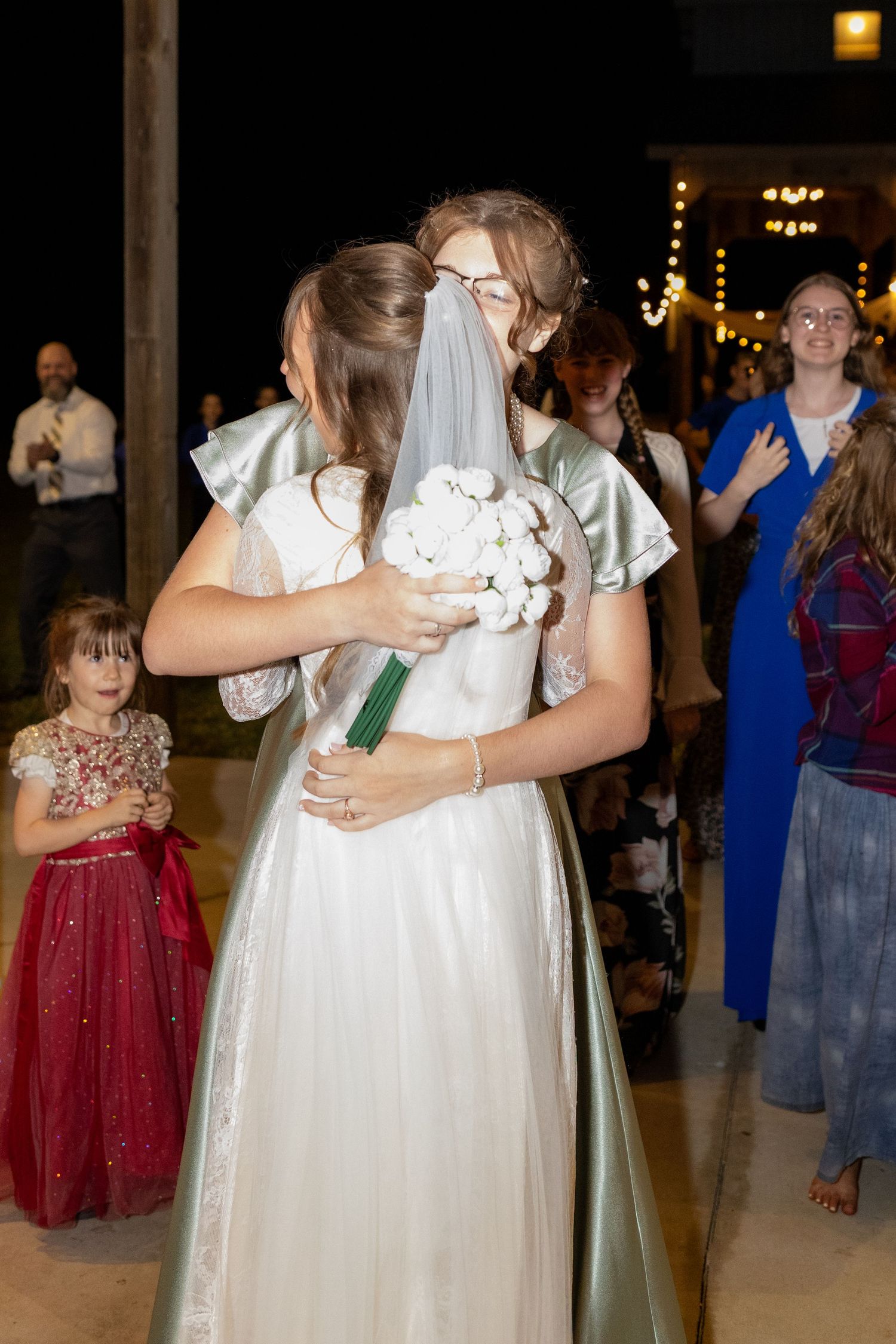 Bride hugging friend after bouquet toss at Dalrymple Farms Enterprise, Alabama