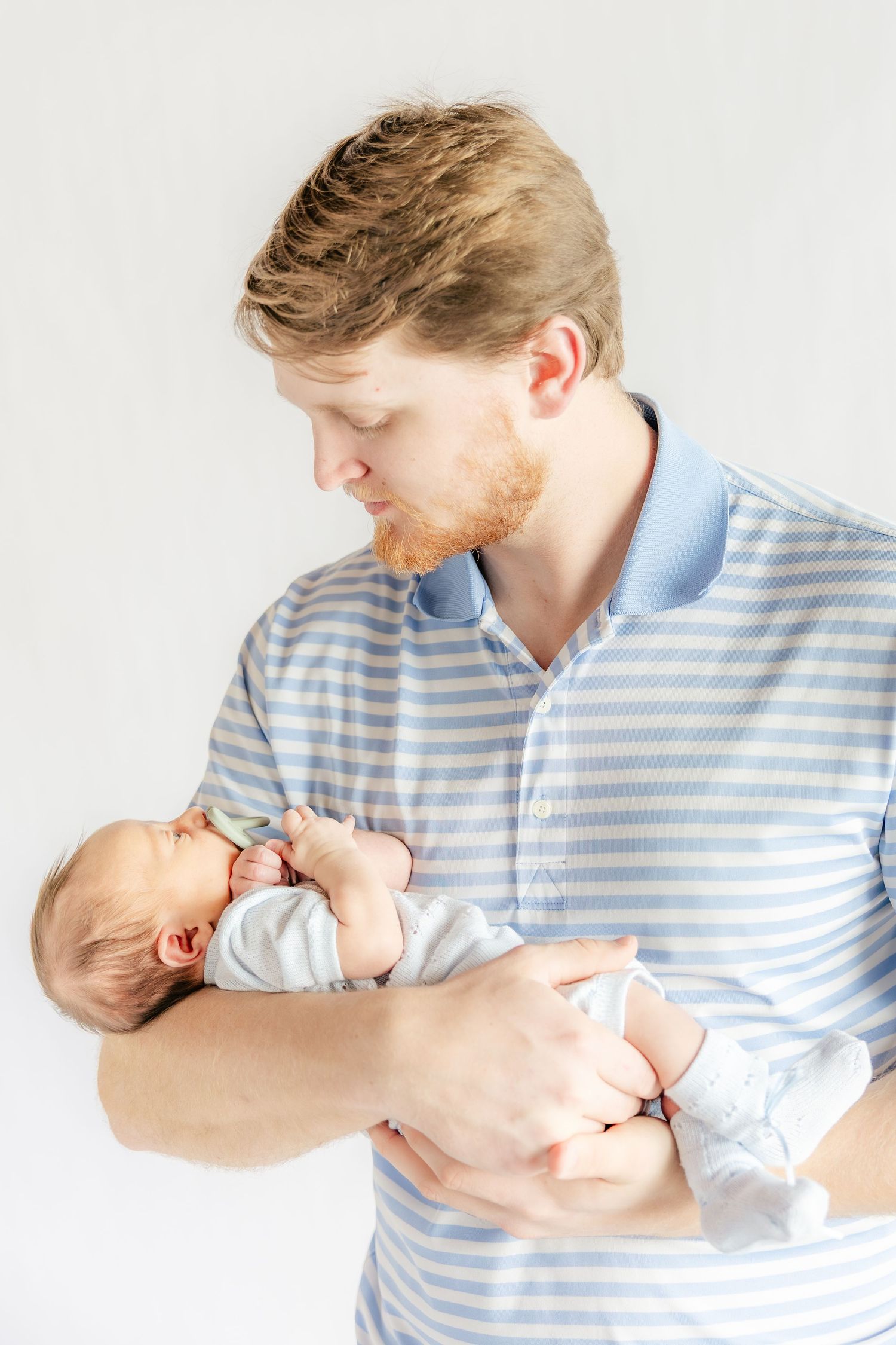 Father holding his baby in a studio in Dothan, Alabama