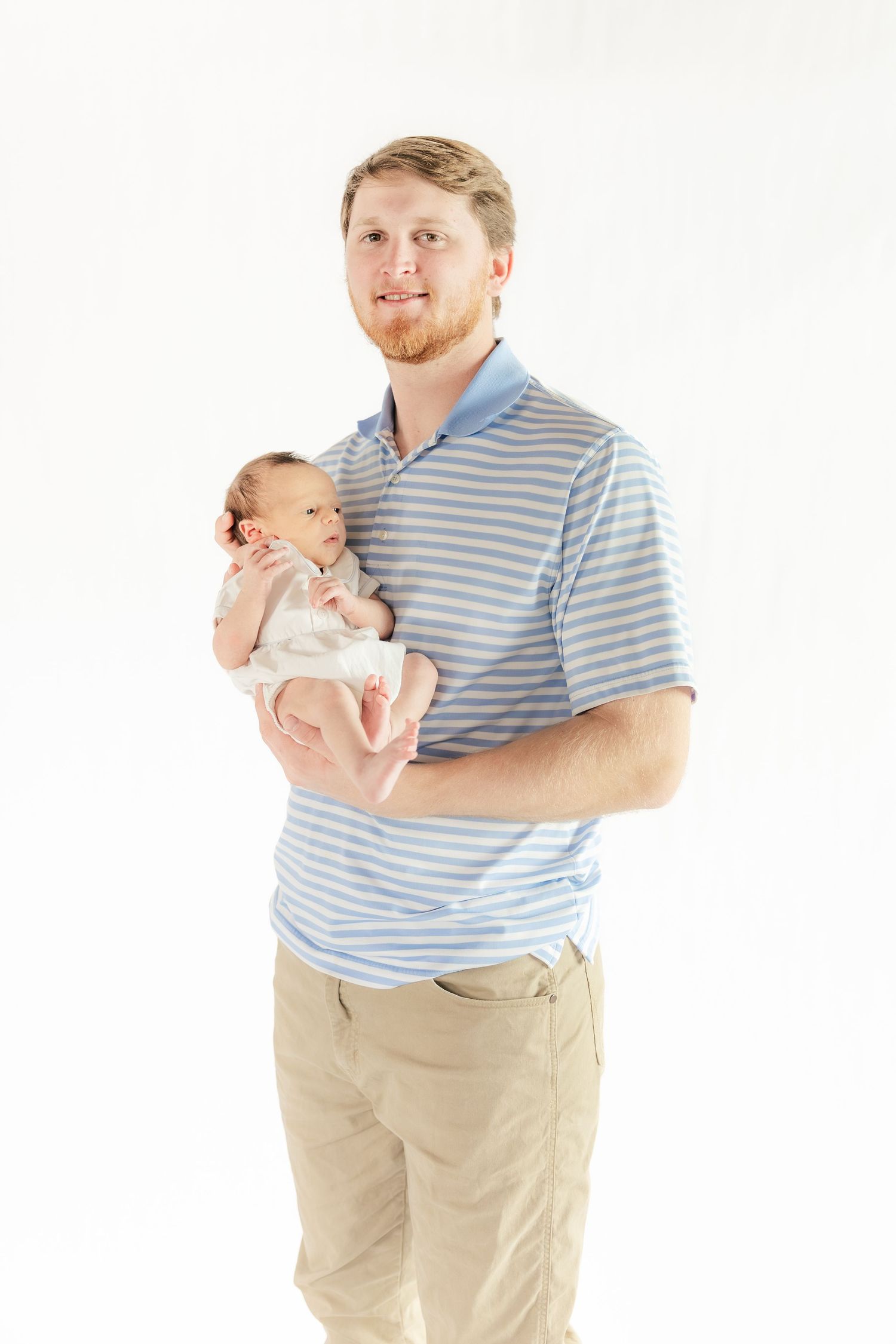 Father holding his baby in a Studio in Dothan, Alabama