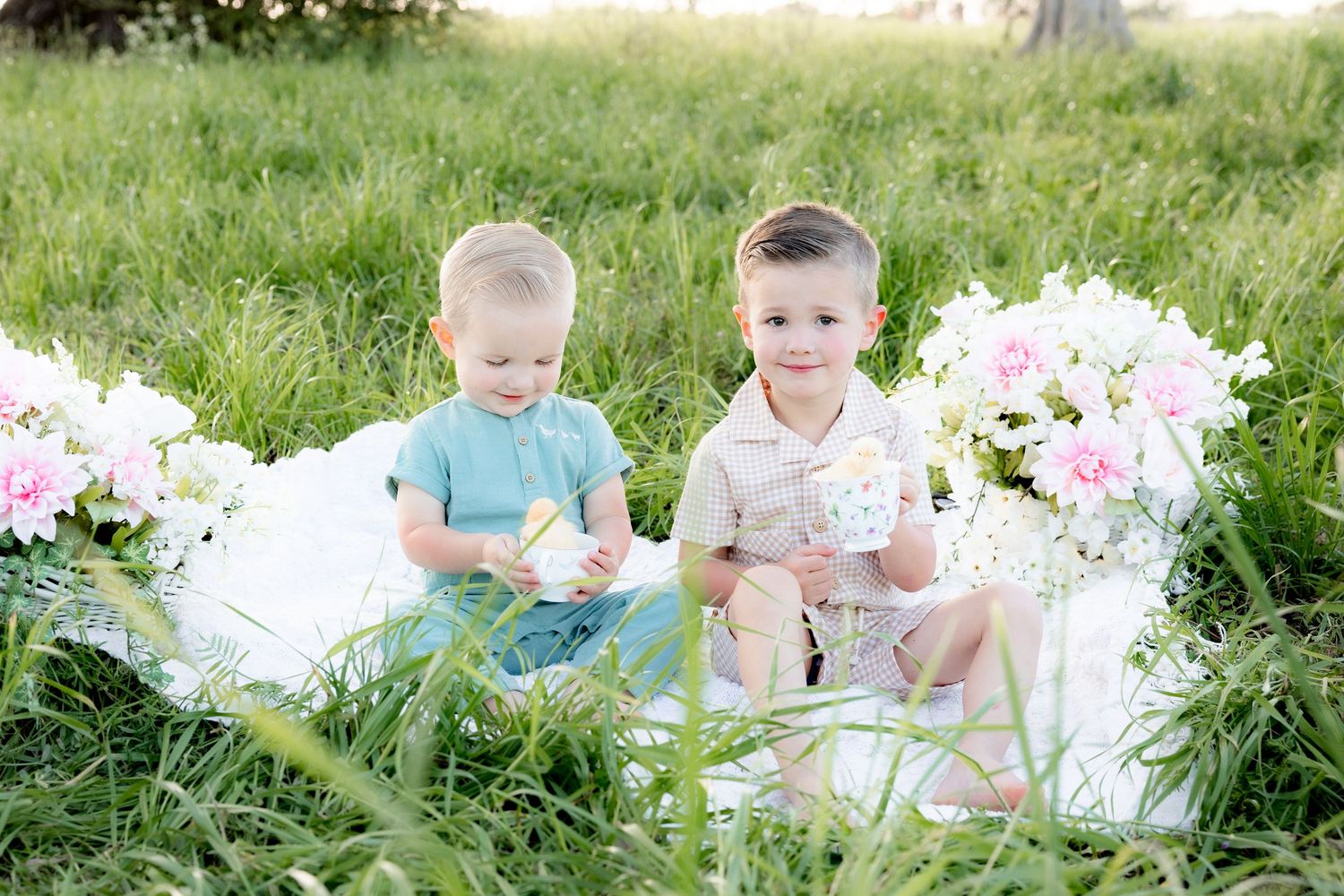 Spring Mini Session with baby chicks in a grass field at sunset near Dothan, Alabama