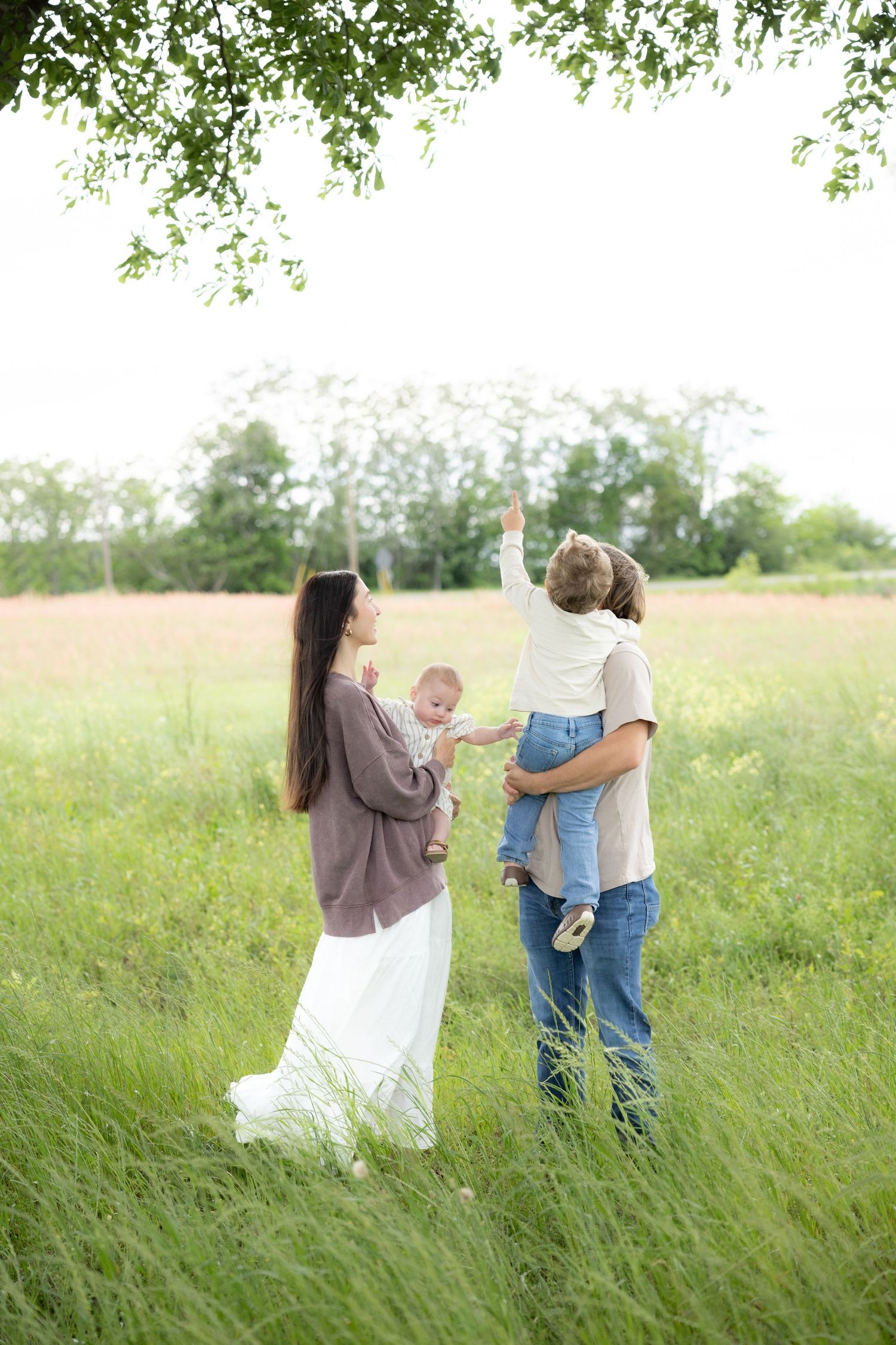 Candid family photos in a grass field | Dothan, Alabama Lifestyle Portrait Photographer