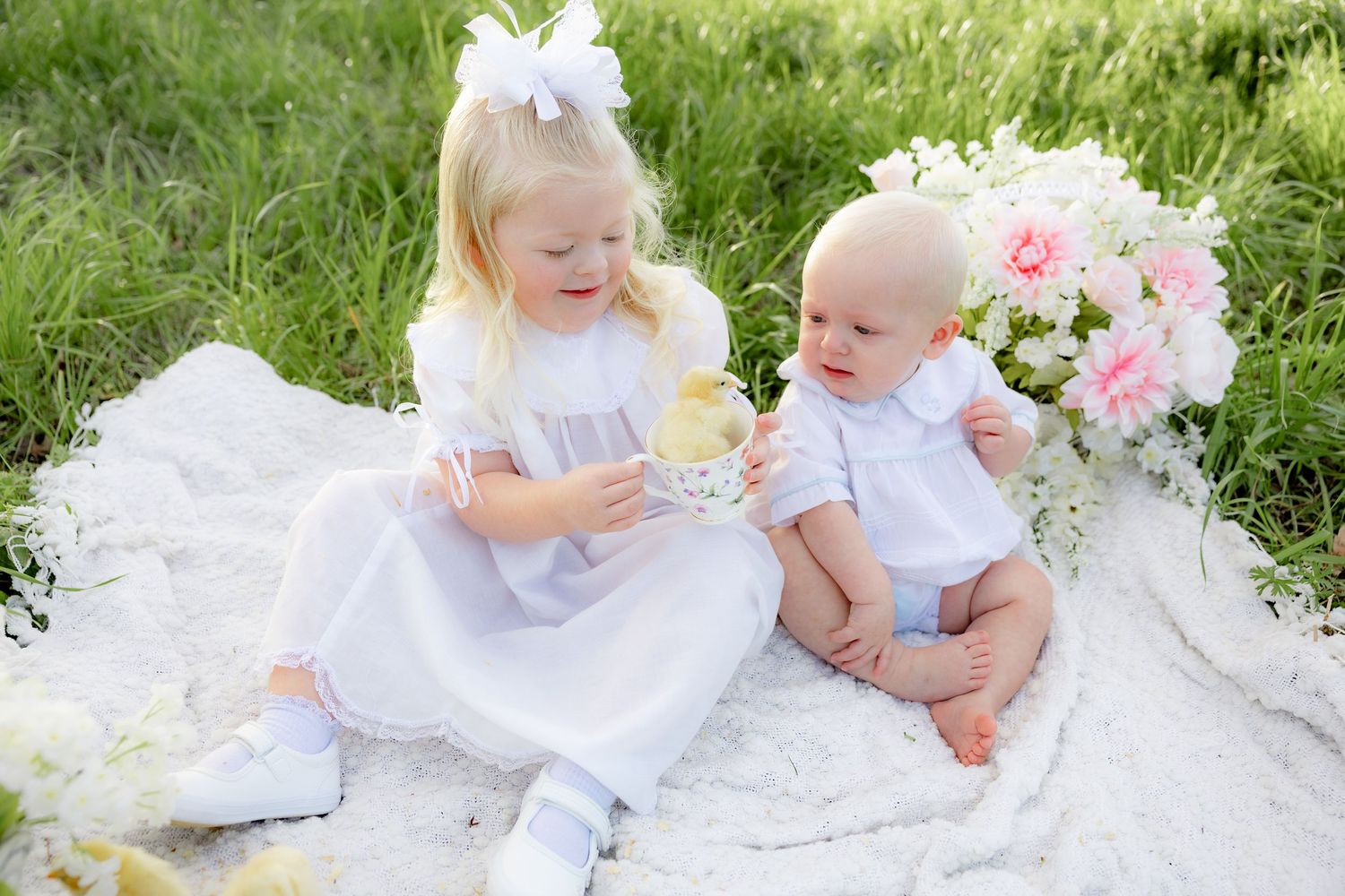 Spring Mini Session with baby chicks in a grass field at sunset near Dothan, Alabama