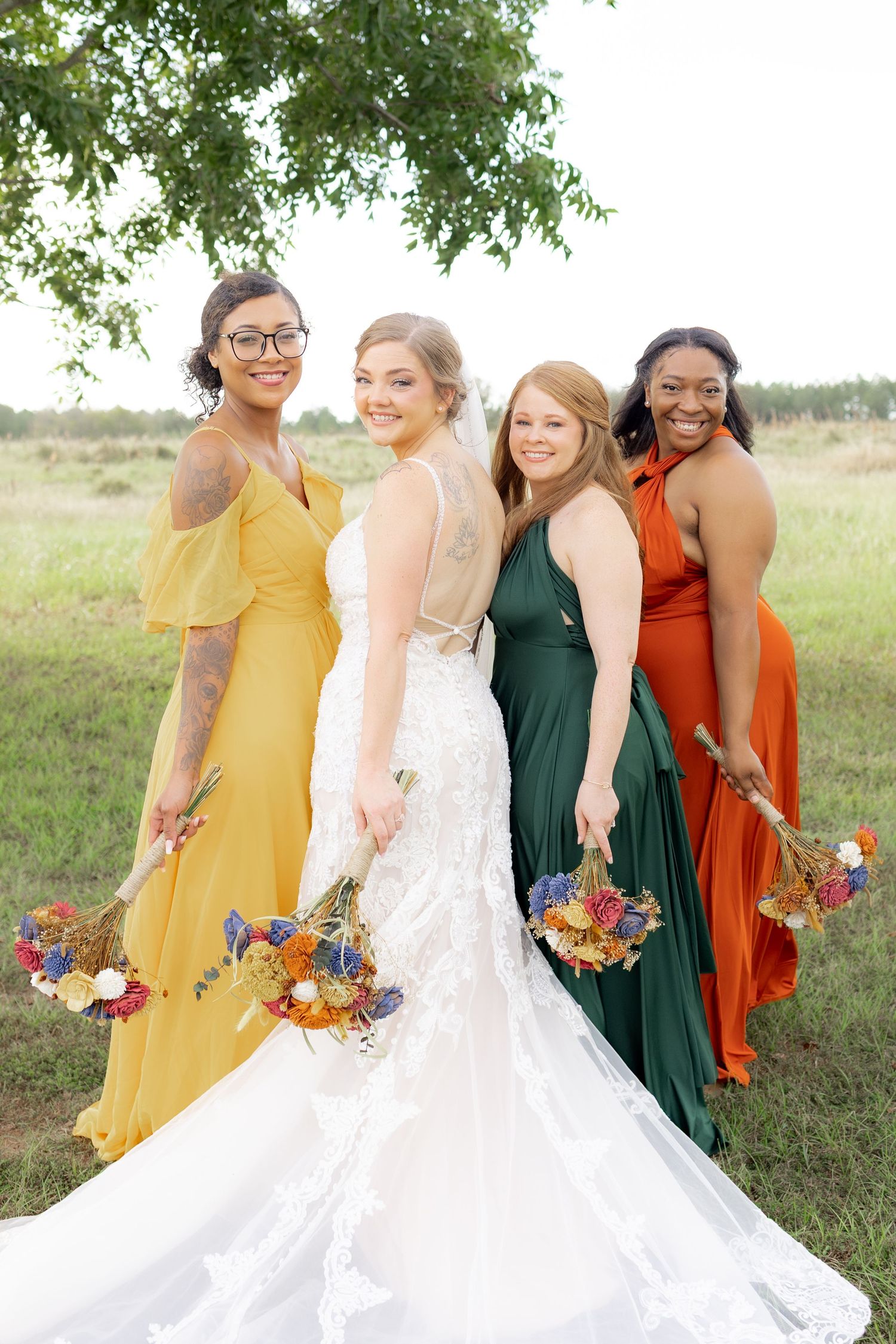 Bridal party posing in a field at sunset at Hilltop Acres Wicksburg, Alabama