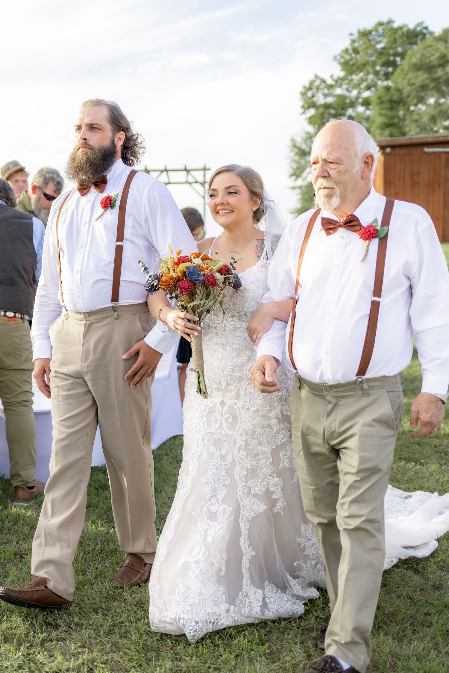 Father and brother giving the bride away at a wedding at Hilltop Acres Wicksburg, Alabama