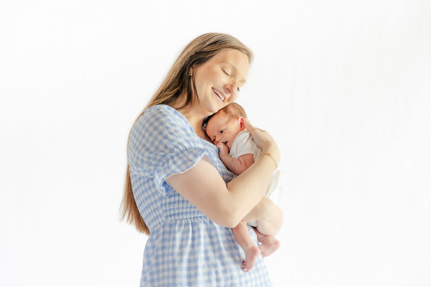 Mother holding her baby in a studio in Dothan, Alabama