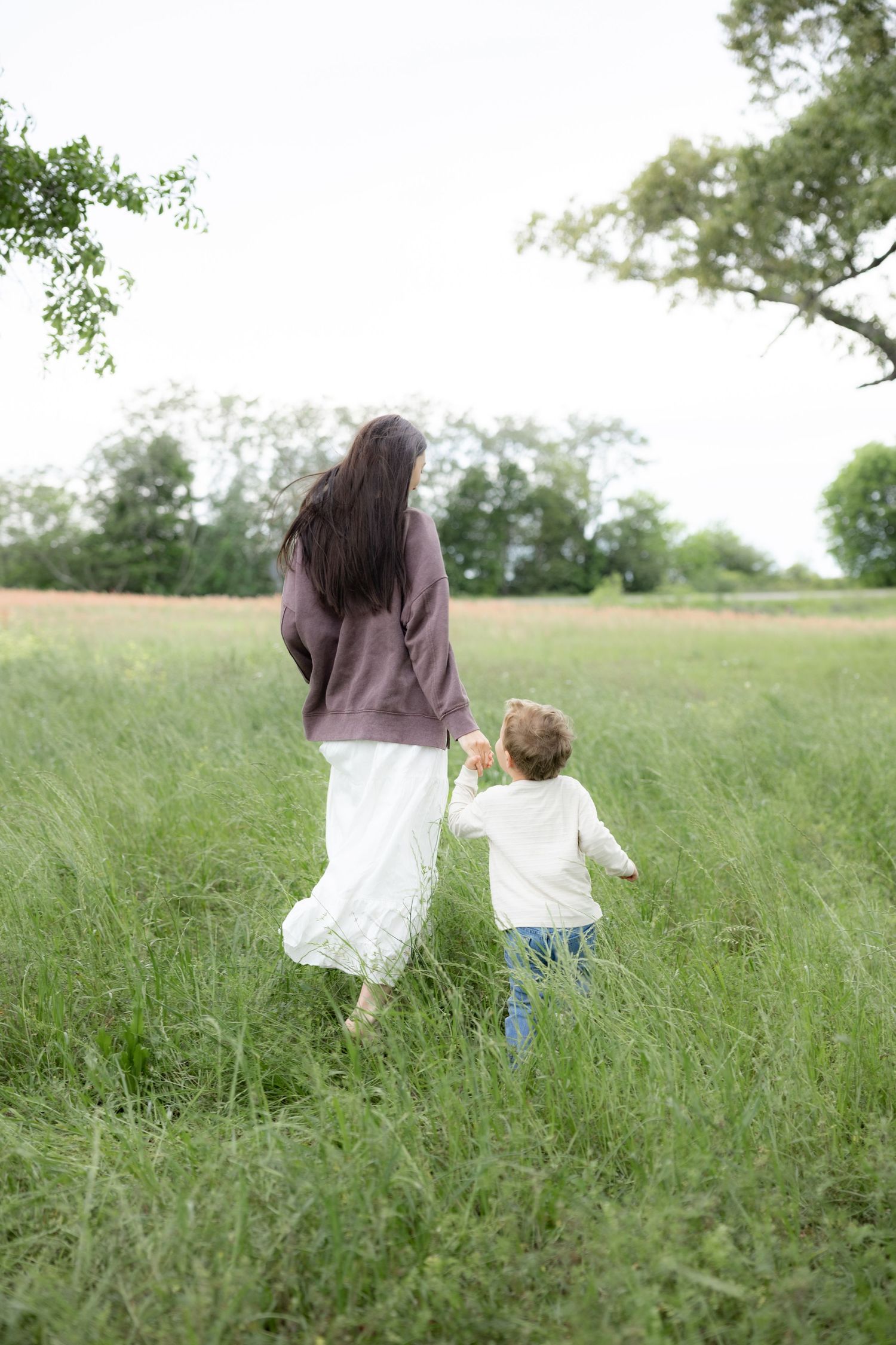 Candid family photos in a grass field | Dothan, Alabama Lifestyle Portrait Photographer