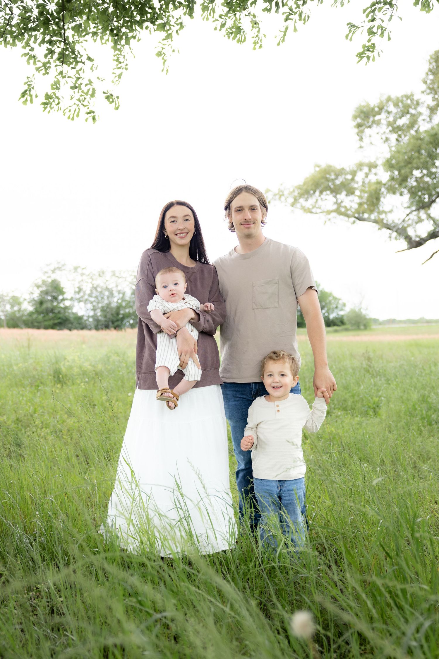 Candid family photos in a grass field | Dothan, Alabama Lifestyle Portrait Photographer
