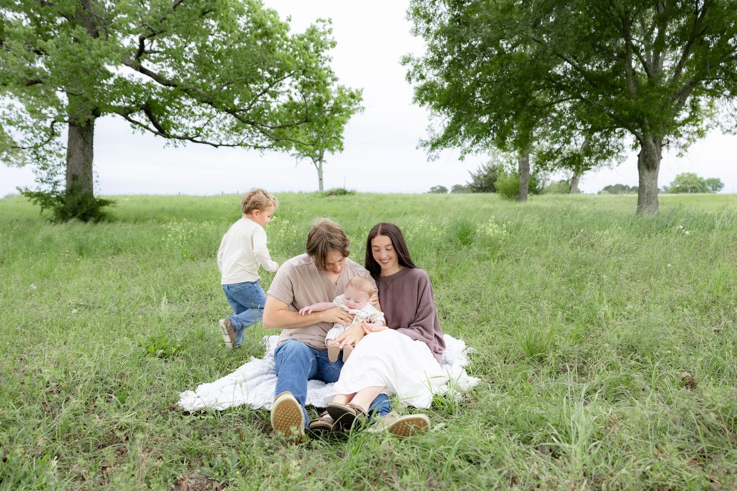 Candid family photos in a grass field | Dothan, Alabama Lifestyle Portrait Photographer