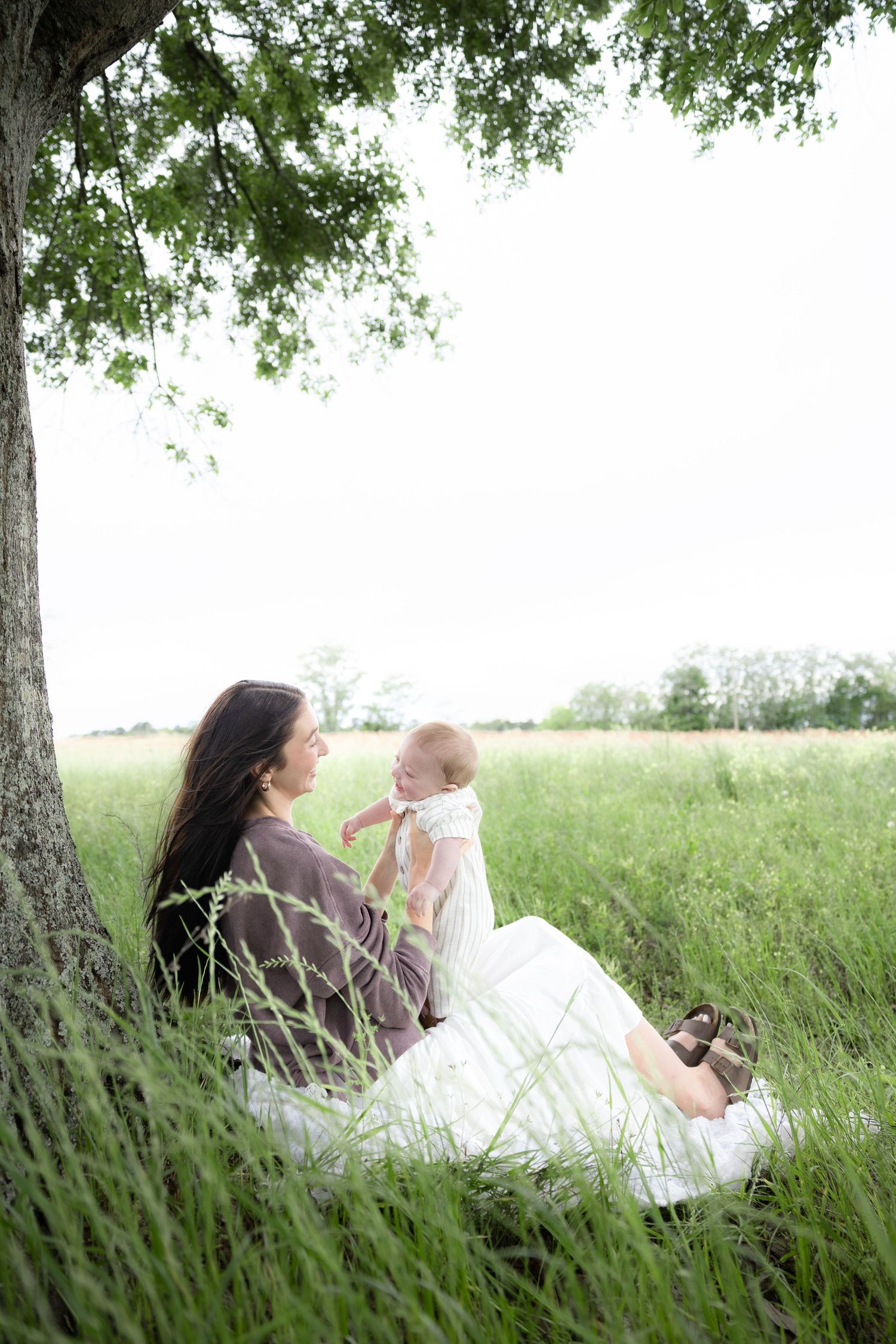 Candid family photos in a grass field | Dothan, Alabama Lifestyle Portrait Photographer