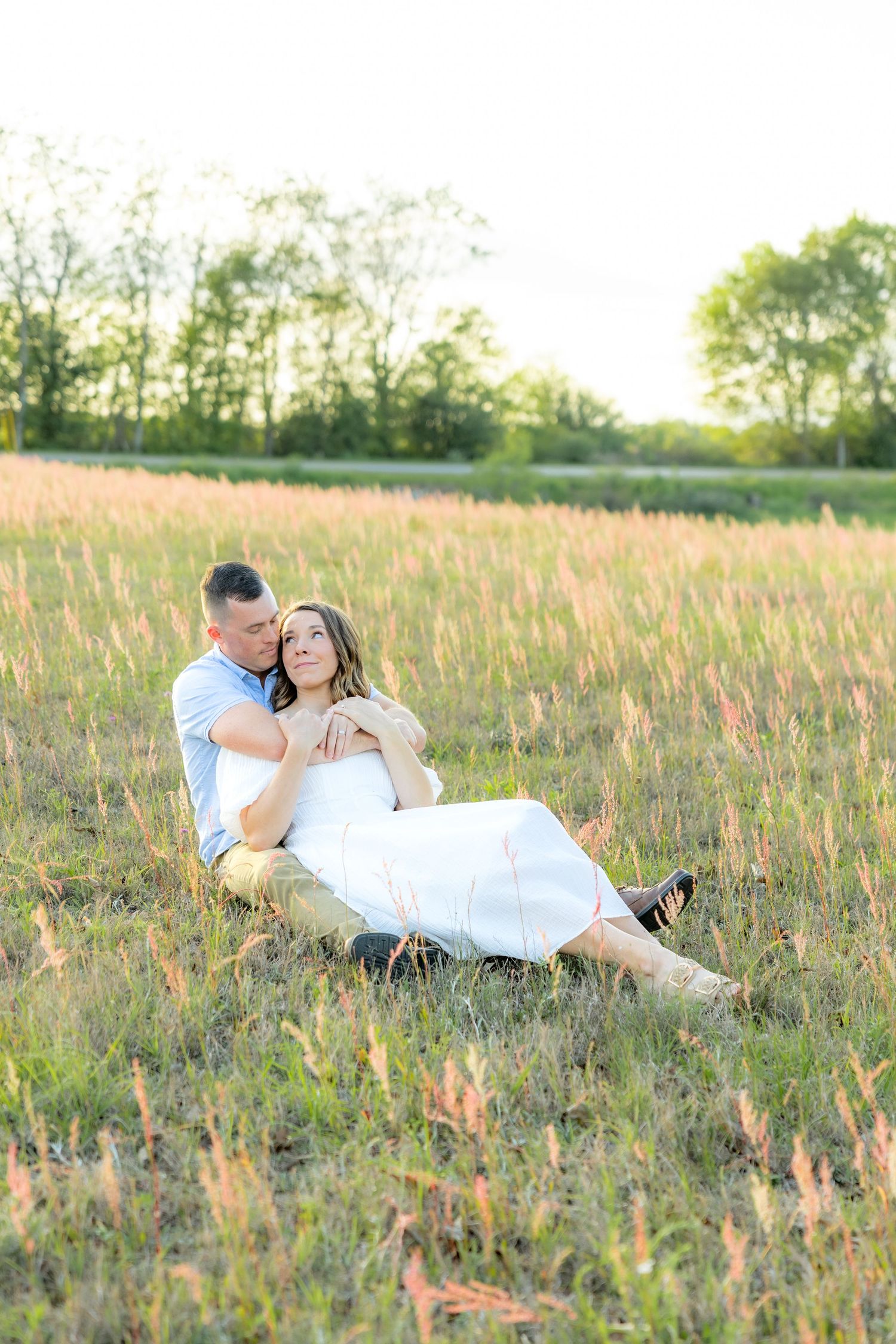 Storytelling couple photos in a tall grass field at sunset in Dothan, Alabama